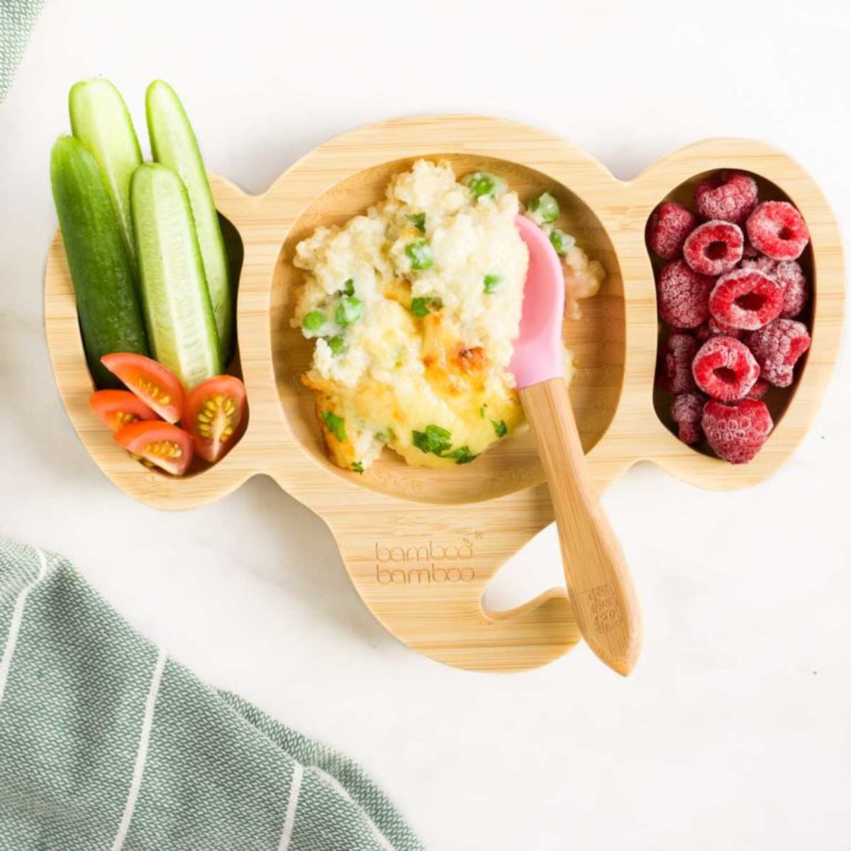 Delicious cheesy quinoa with fruits and veggies in a wooden bowl.