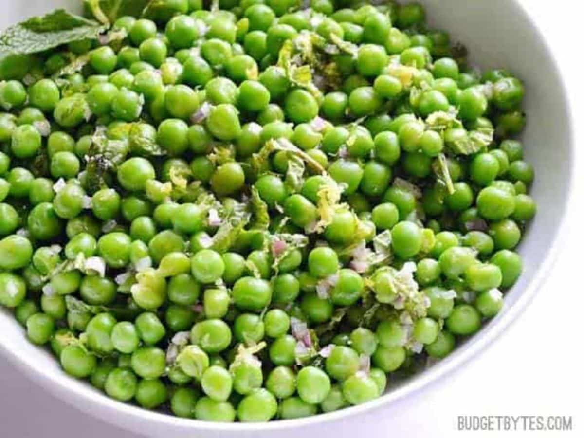 Flavorful mint pea salad in a white bowl.