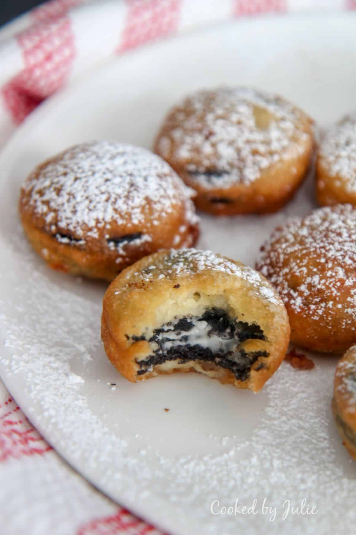 Delicious deep fried oreos on a white plate.