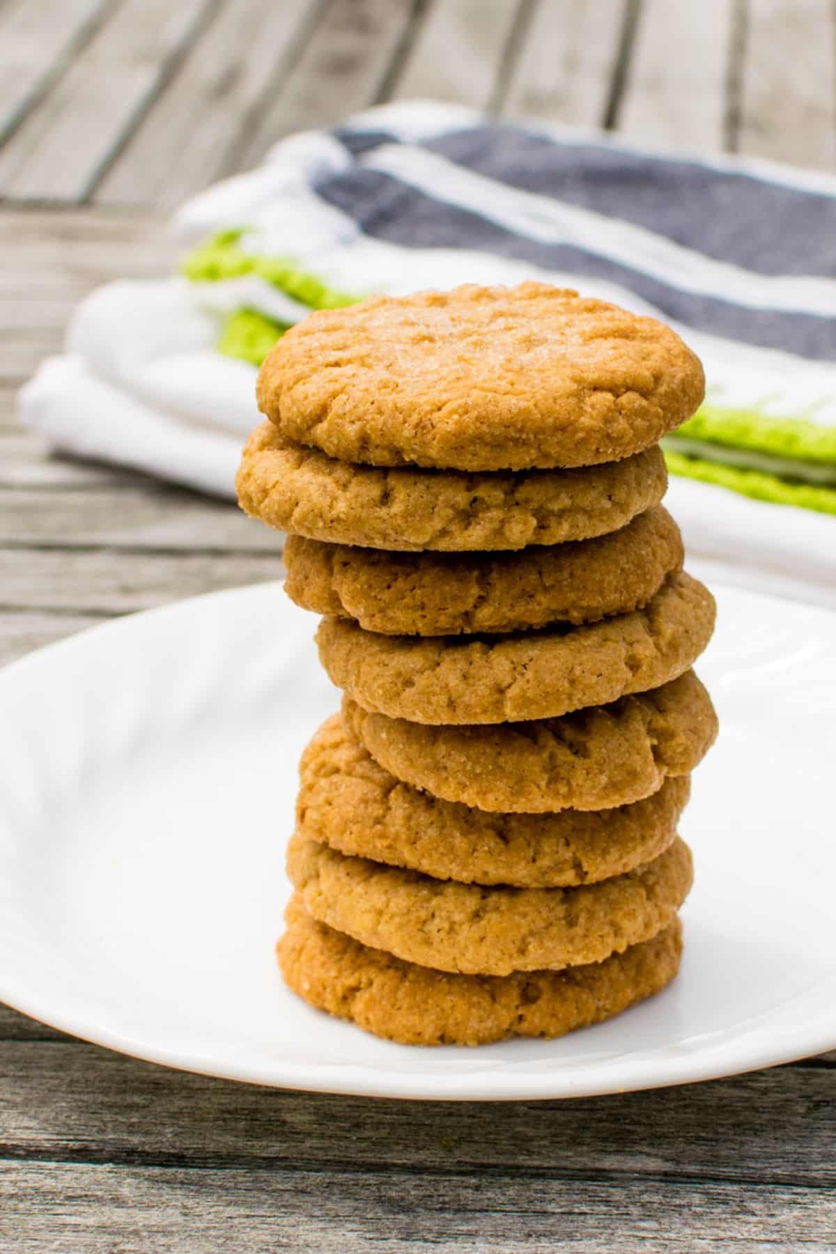 A pile of 3-ingredient peanut butter cookieson a white plate.