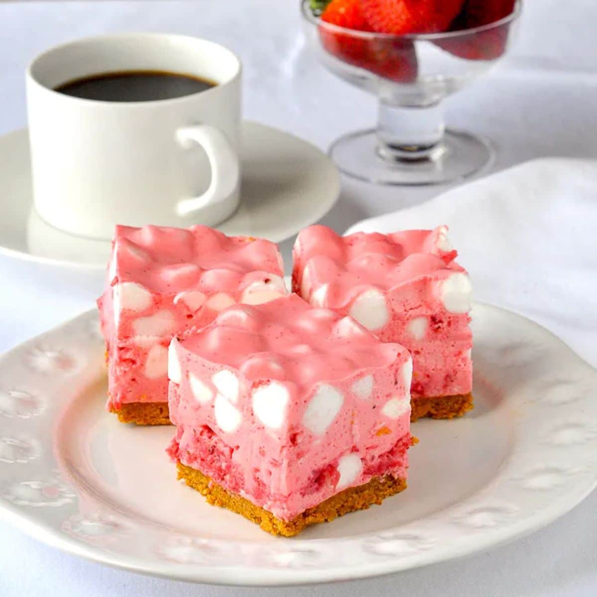 Scrumptious strawberry chiffon squares on a white plate.