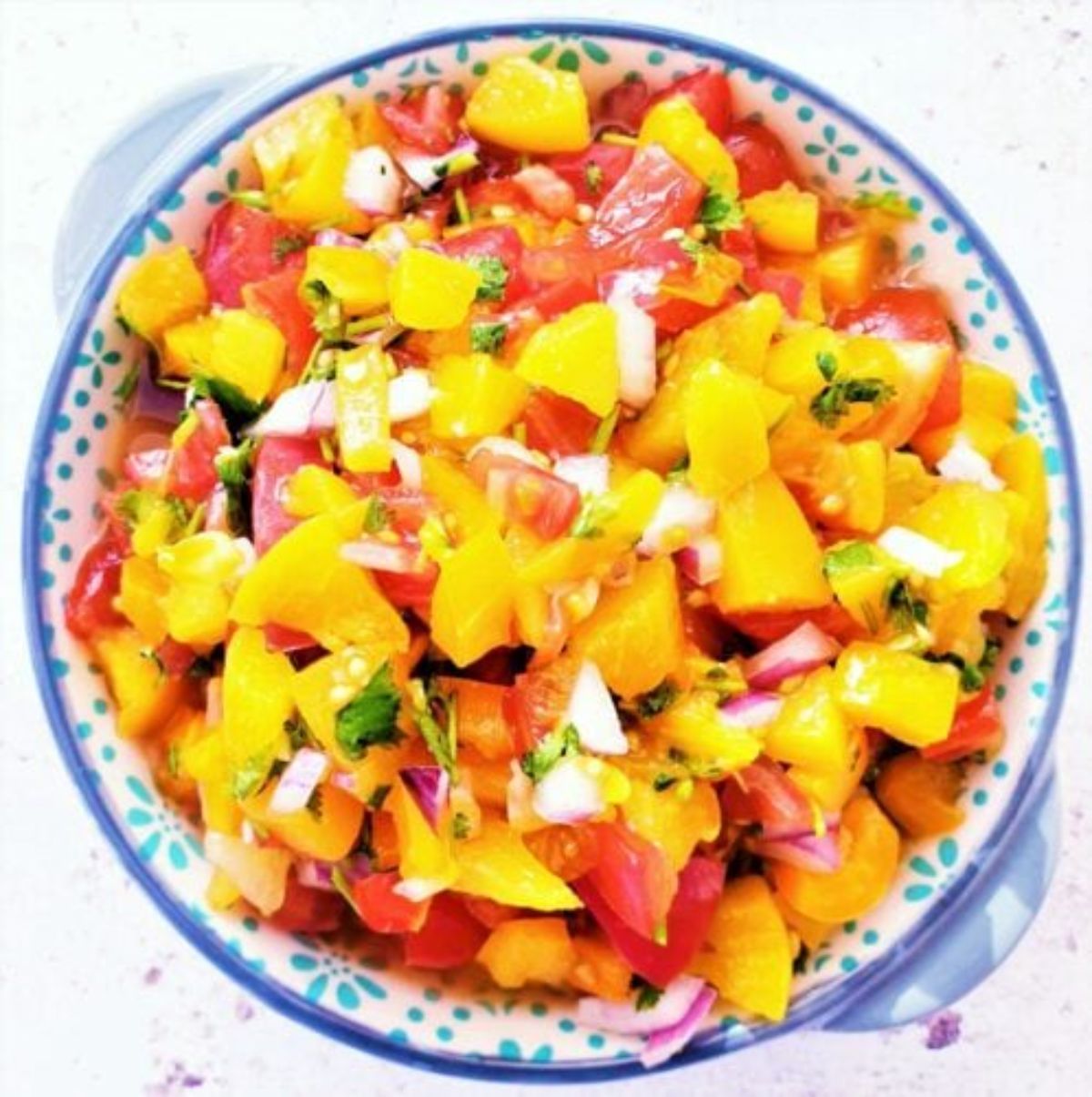 Mouth-watering peach salsa in a bowl.