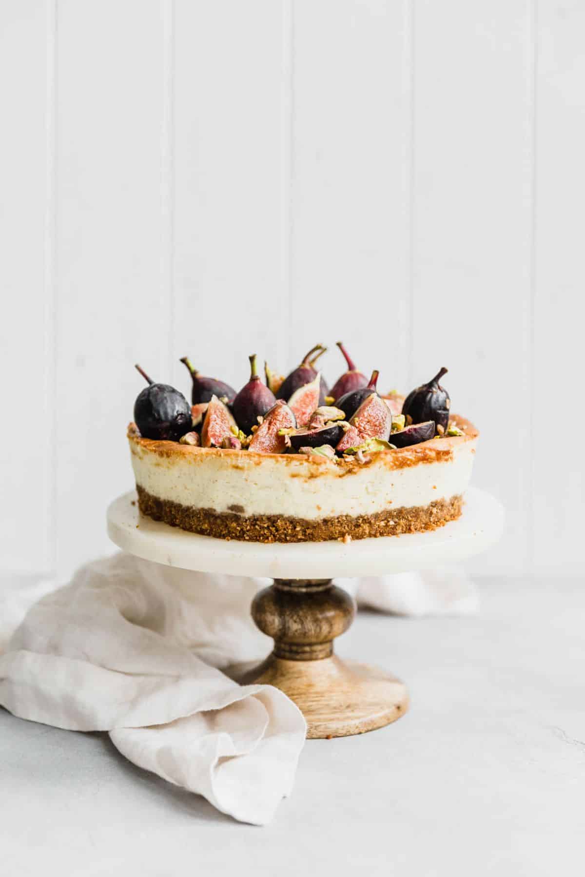 Mouth-watering vanilla bean cheesecake on a cake tray.