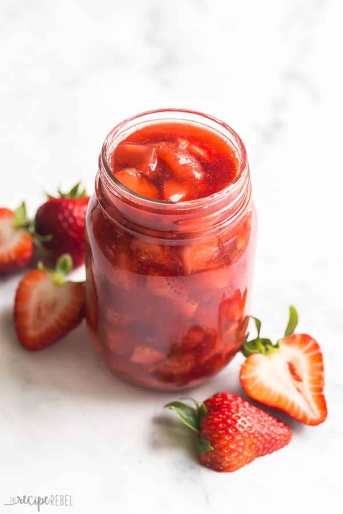 Juicy strawberry sauce in a glass jar.