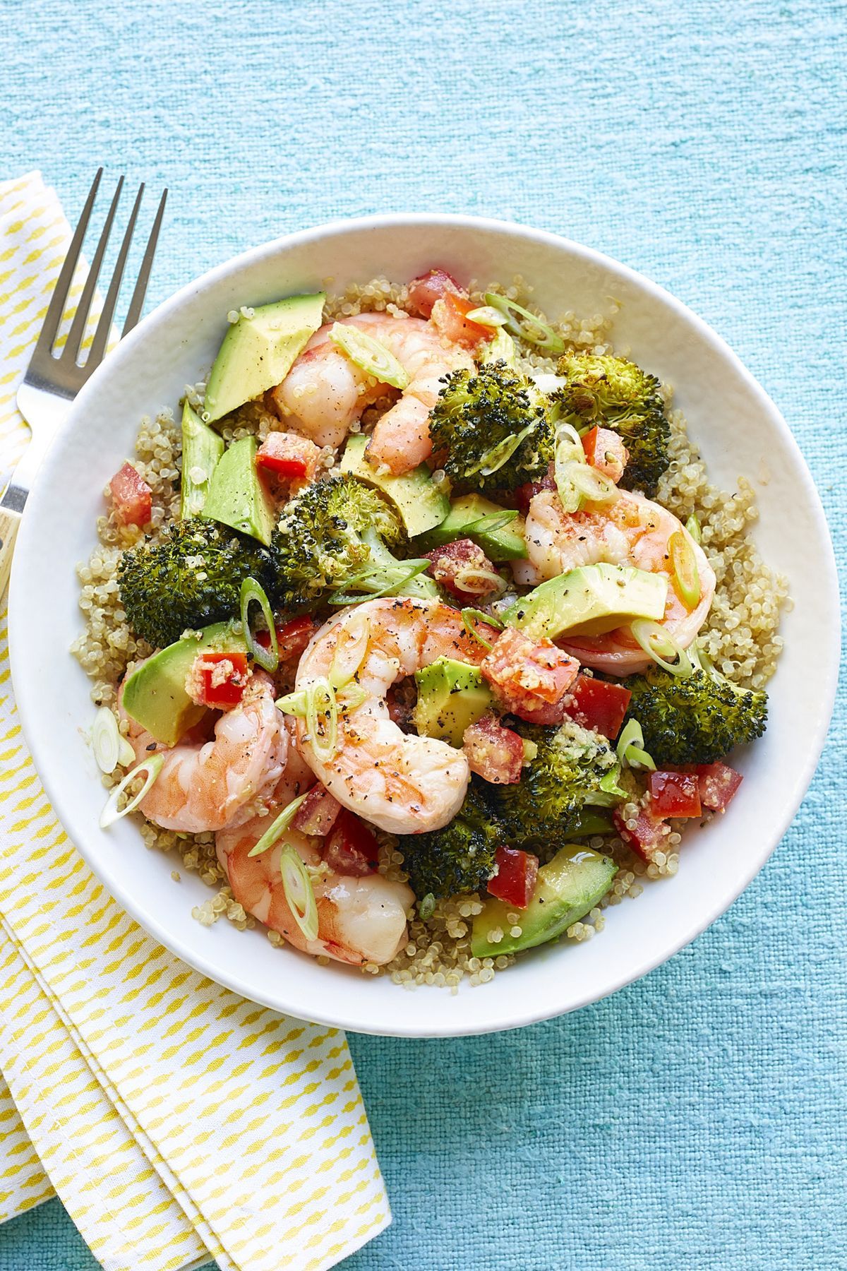 Healthy quinoa shrimp in a white bowl.