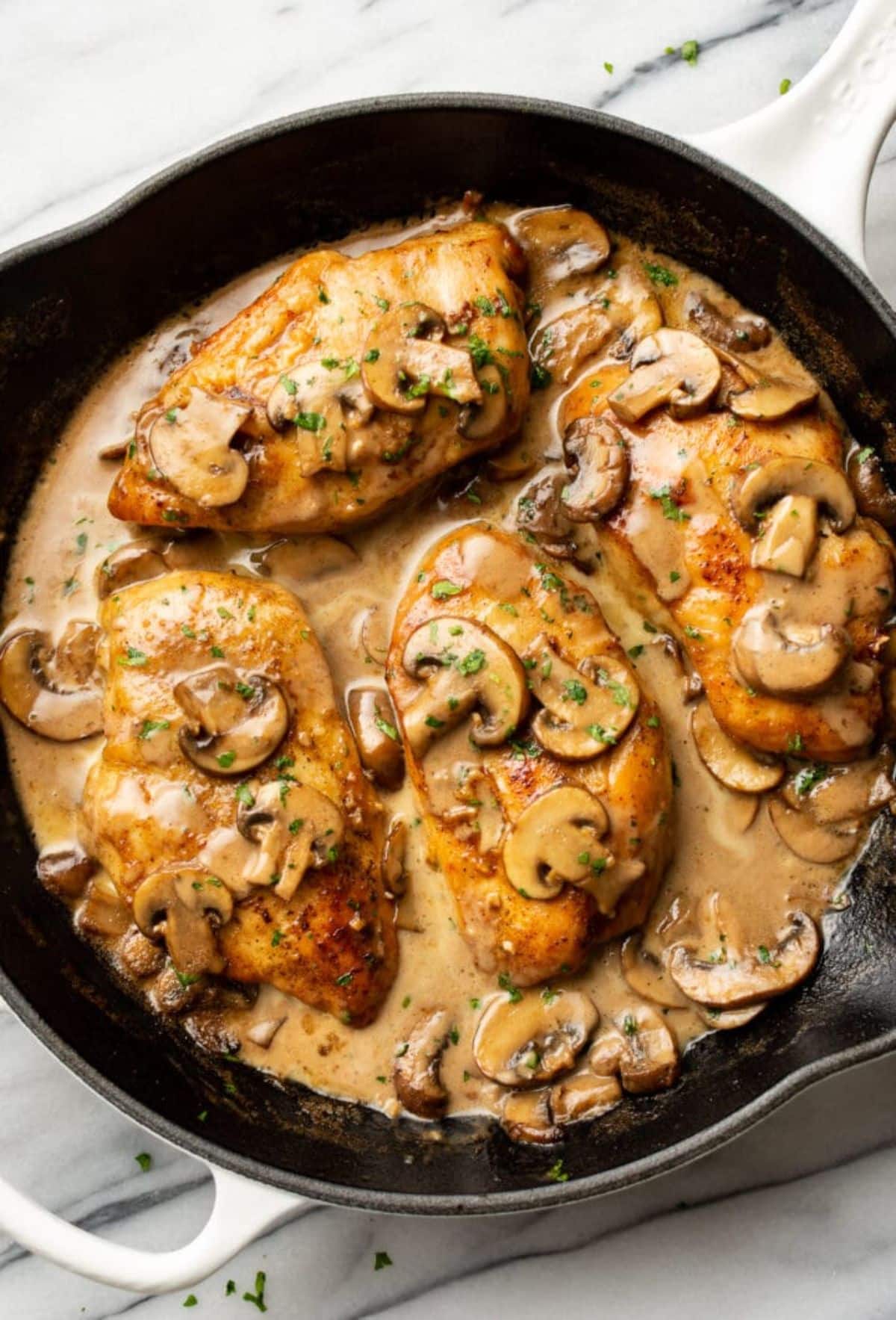 Scrumptious easy chicken marsala in a black skillet.