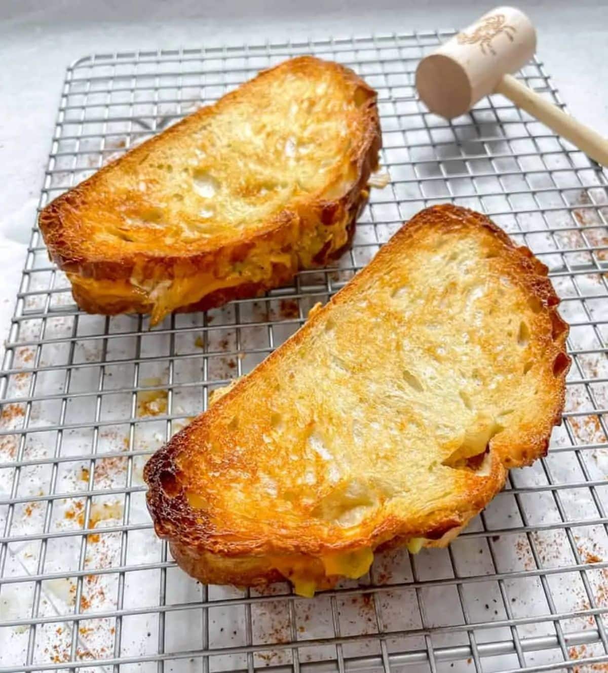Two crunchy easy crab melts on a rest grid.