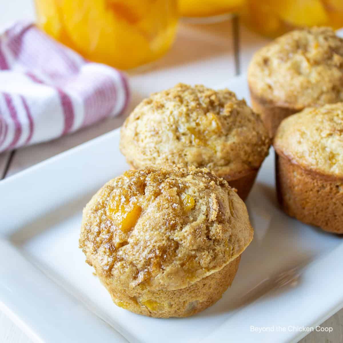 Mouth-watering peach muffins on a white tray.