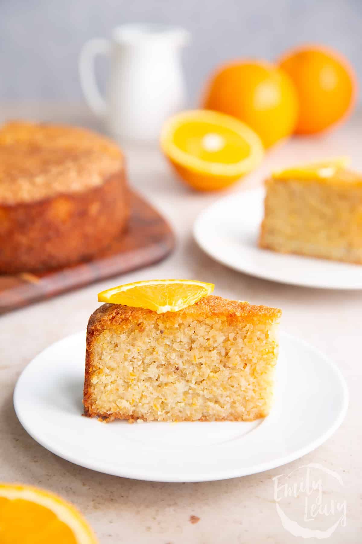 A piece of orange, almond, and quinoa cake on a white plate.