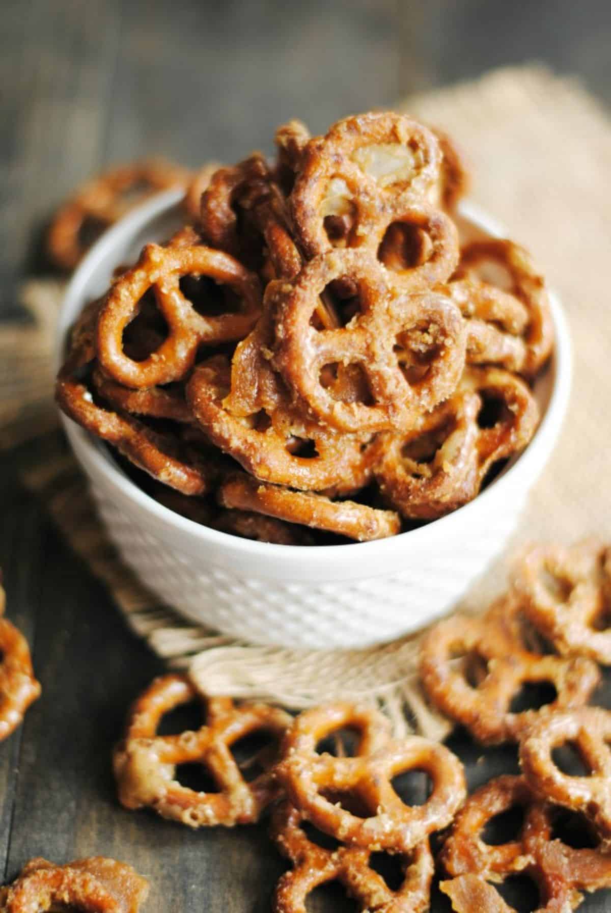 Crispy maple glazed pretzels in a white bowl.