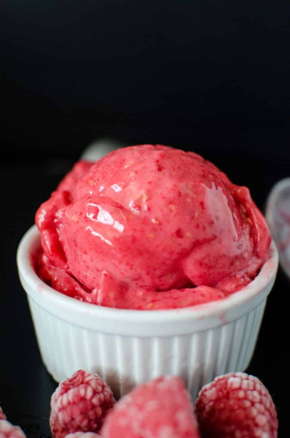 Fresh strawberry sorbet in a white bowl.