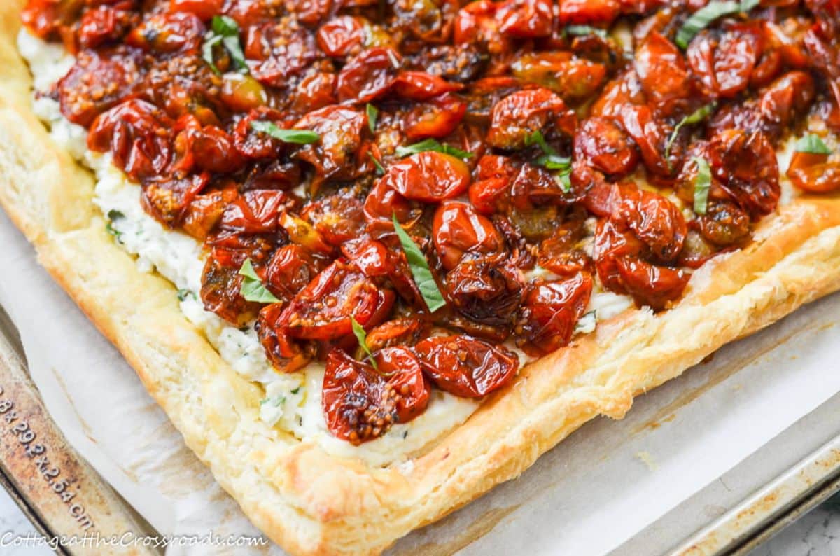 Scrumptious roasted cherry tomato tart on a baking tray.