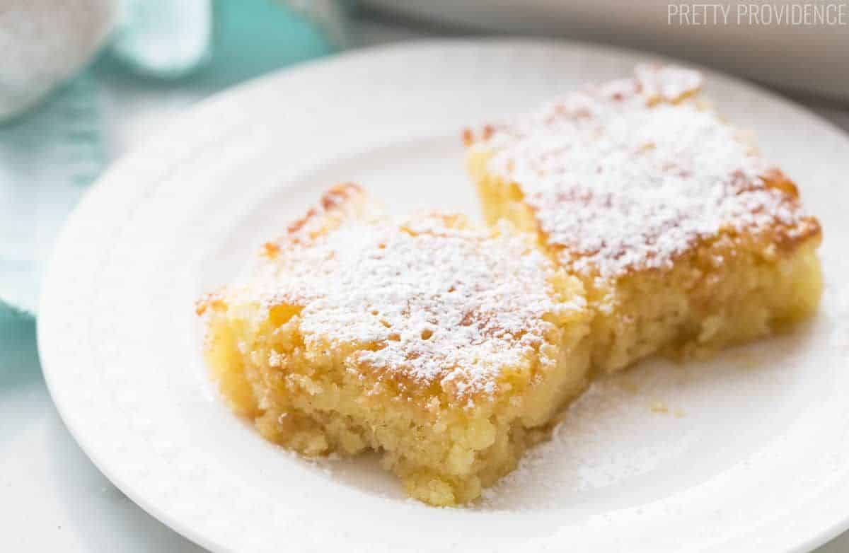Two delicious citrus pineapple bars on a white plate.