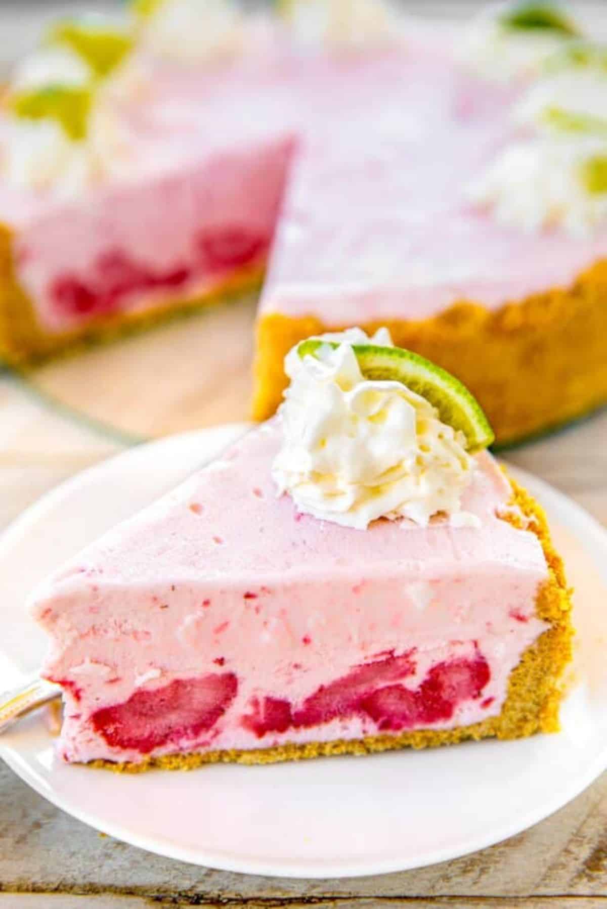 A piece of frozen strawberry margarita pie on a white plate.