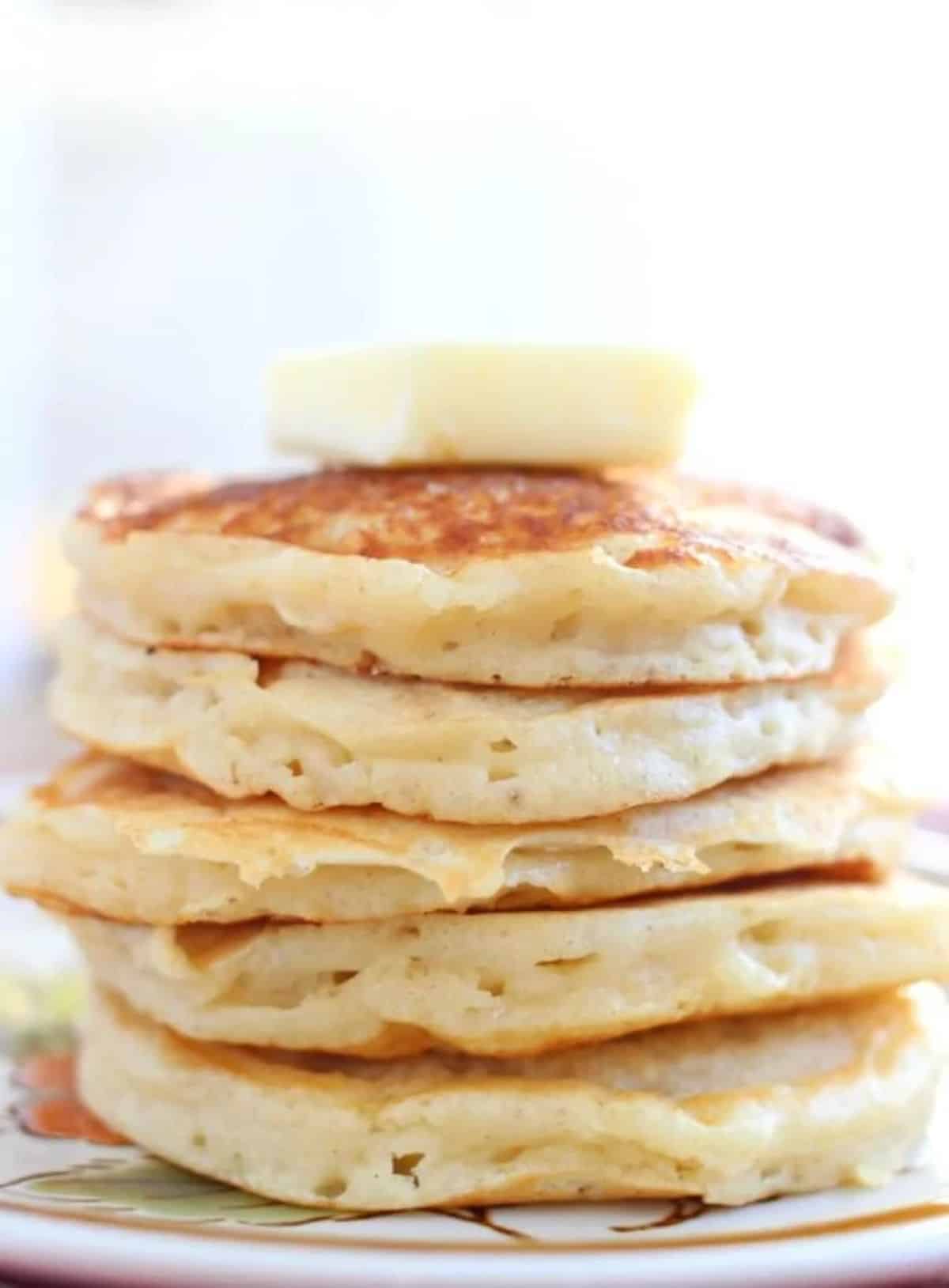 A pile of greek yogurt pancakes on a plate.