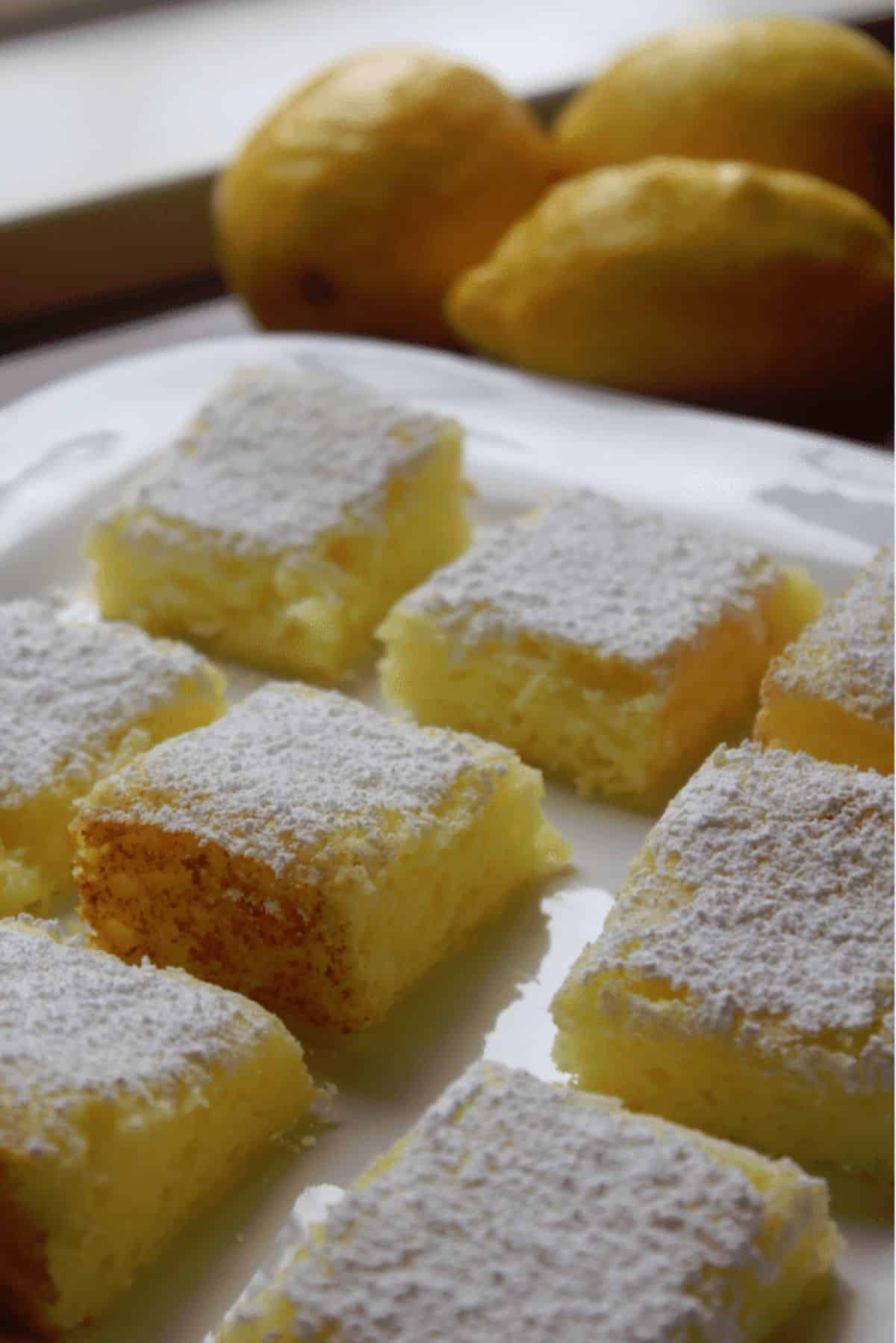 Flavorful two-ingredient lemon bars on a white tray.