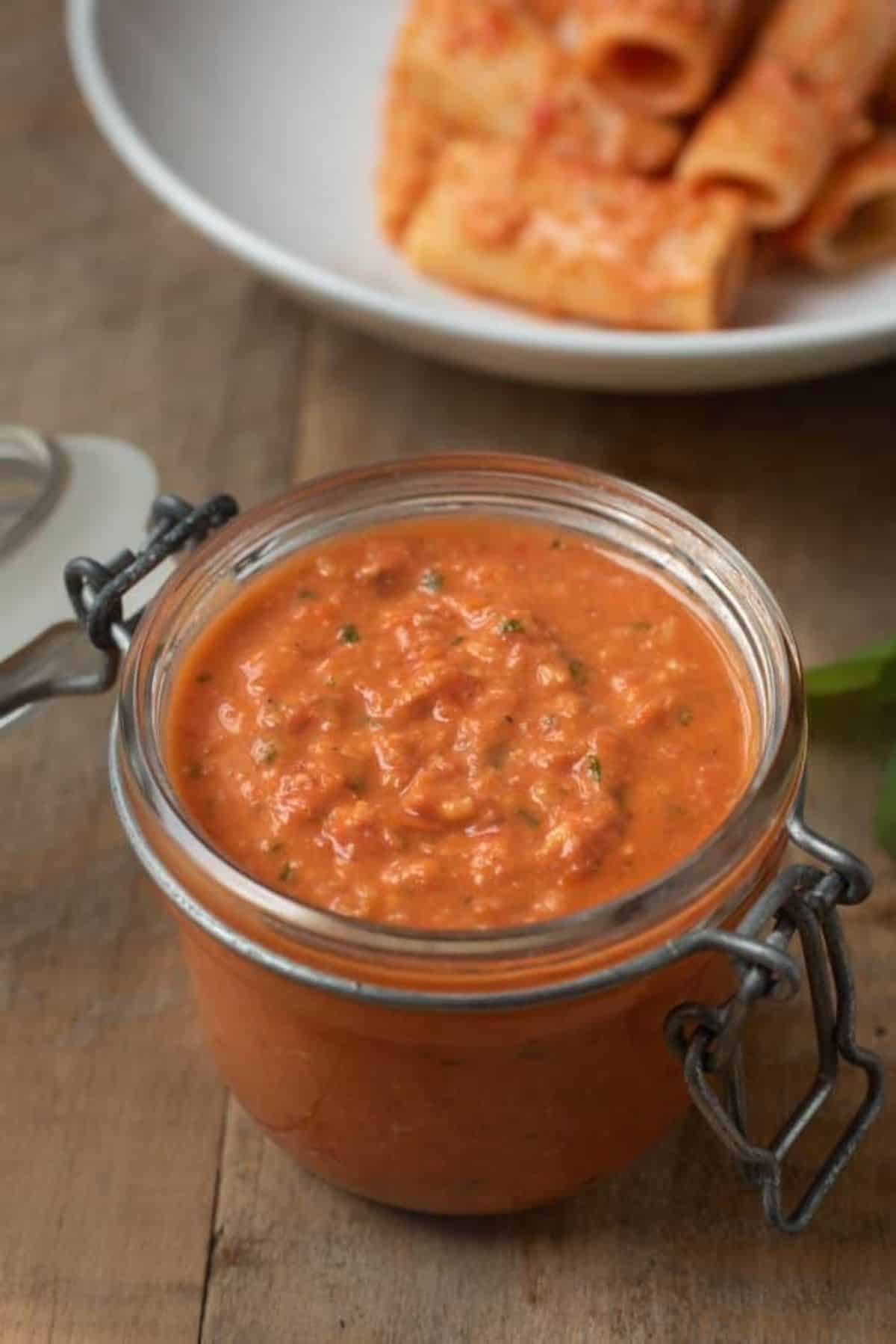 Creamy sicilian tomato pesto sauce in a glass jar.