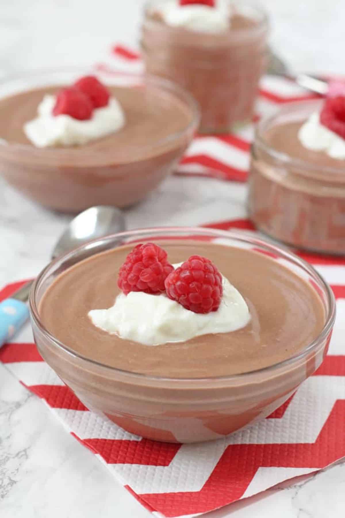 Mouth-watering greek yogurt chocolate mousses in glass bowls.