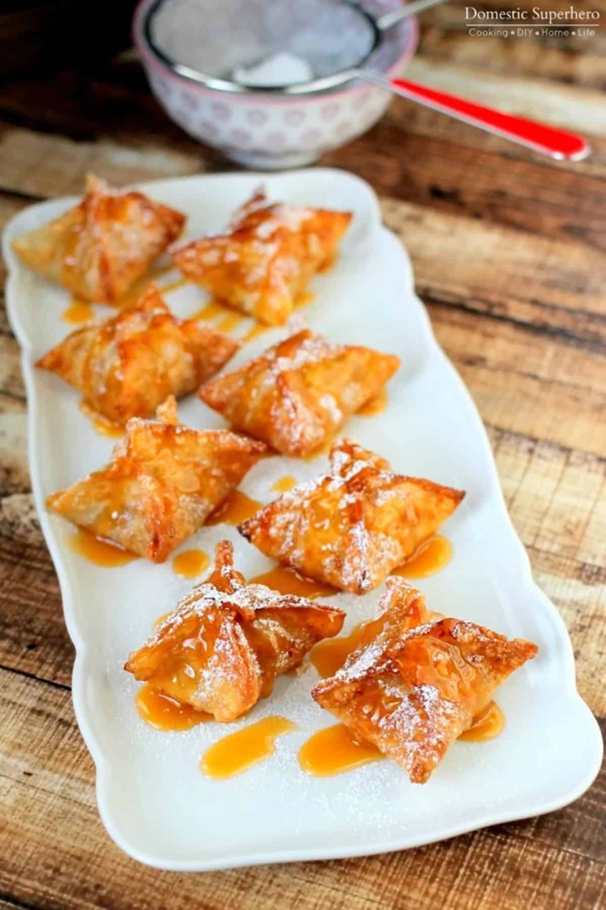 Crunchy dessert dumplings on a white tray.