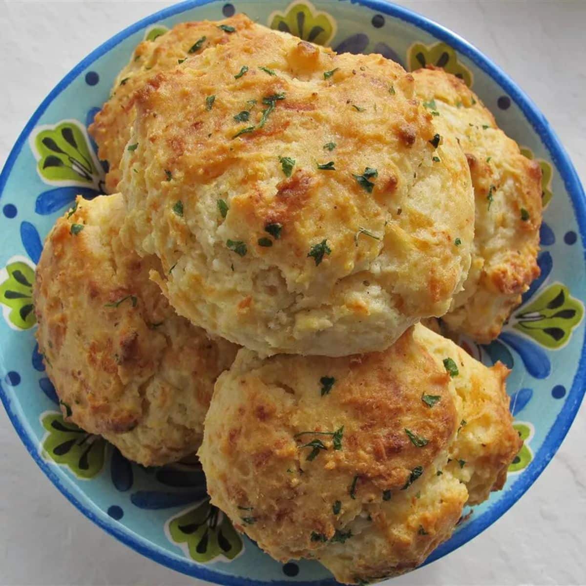 Crispy cheddar biscuits with old bay in a blue bowl.