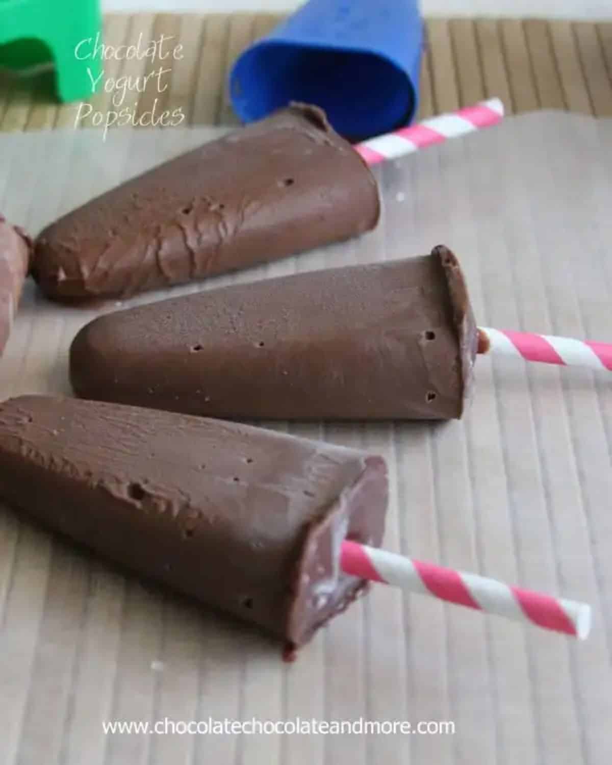 Crunchy chocolate yogurt popsicles on a table.