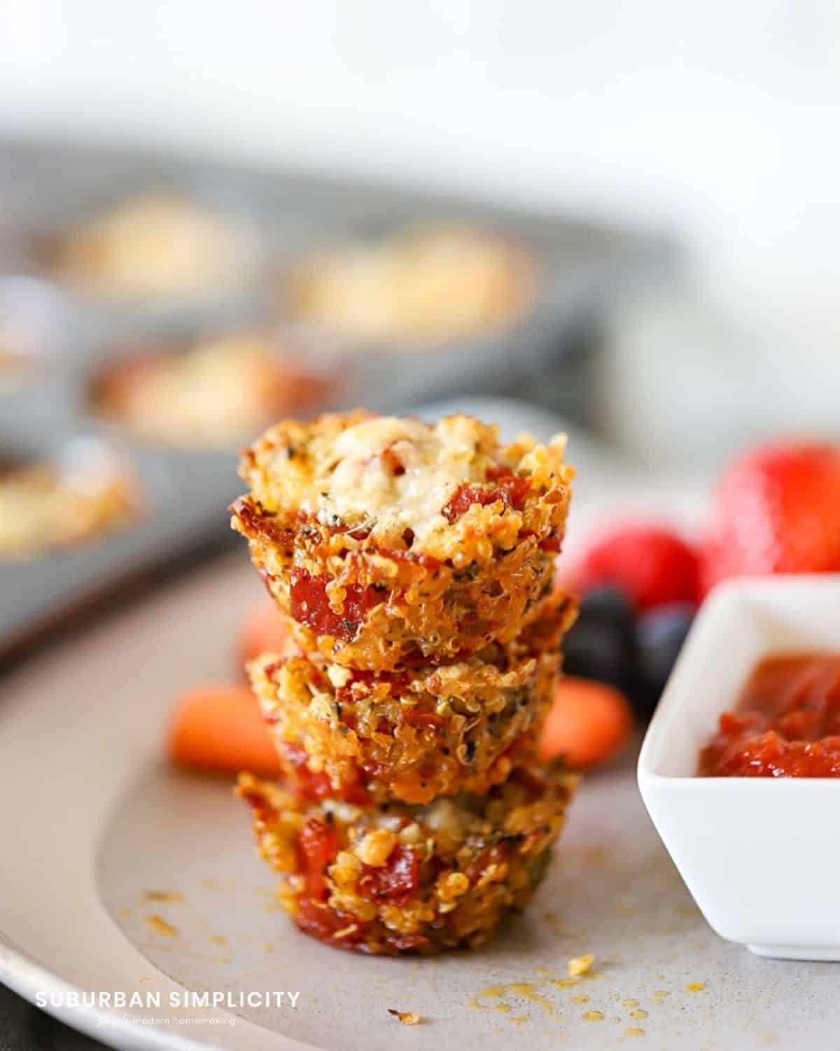 A pile of quinoa pizza bites on a gray plate.