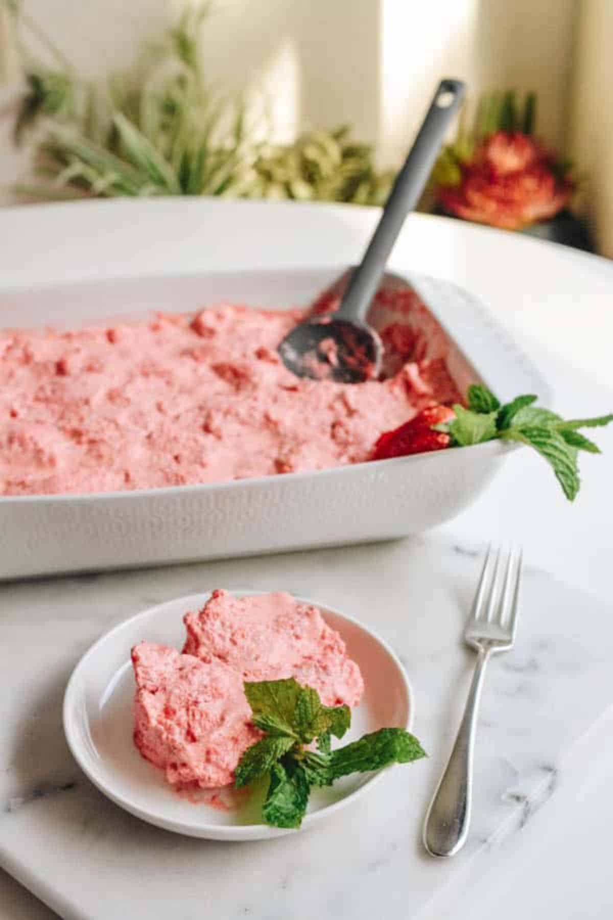 Scrumptious strawberry jello angel foods cake dessert in a casserole and on a white plate.