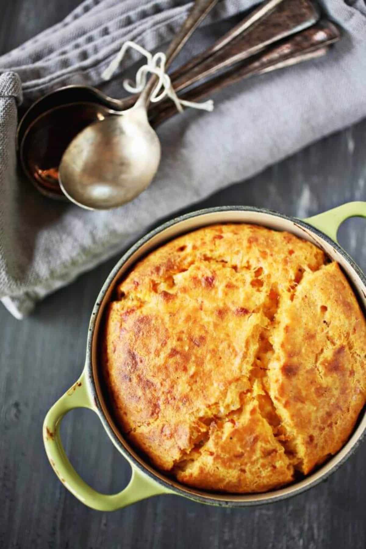 Mouth-watering smoked gouda sweet potato spoonbread in a pot.