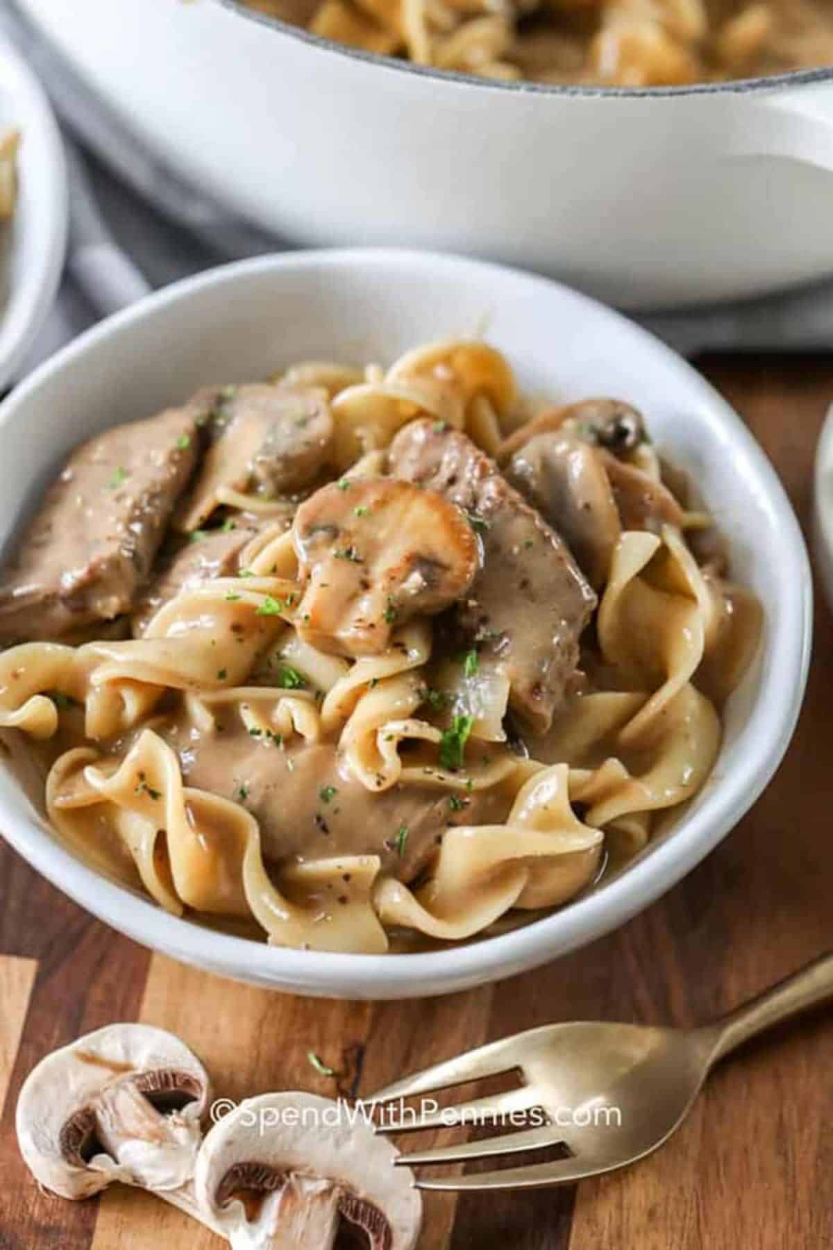 Juicy easy beef stroganoff in a white bowl.
