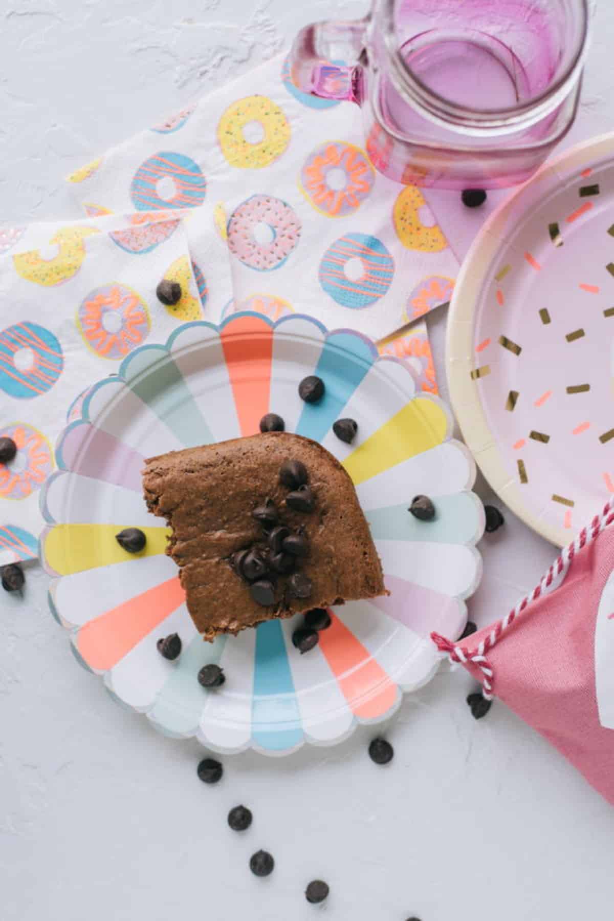 A piece of chocolate pudding dump cake on a colofrful plate.