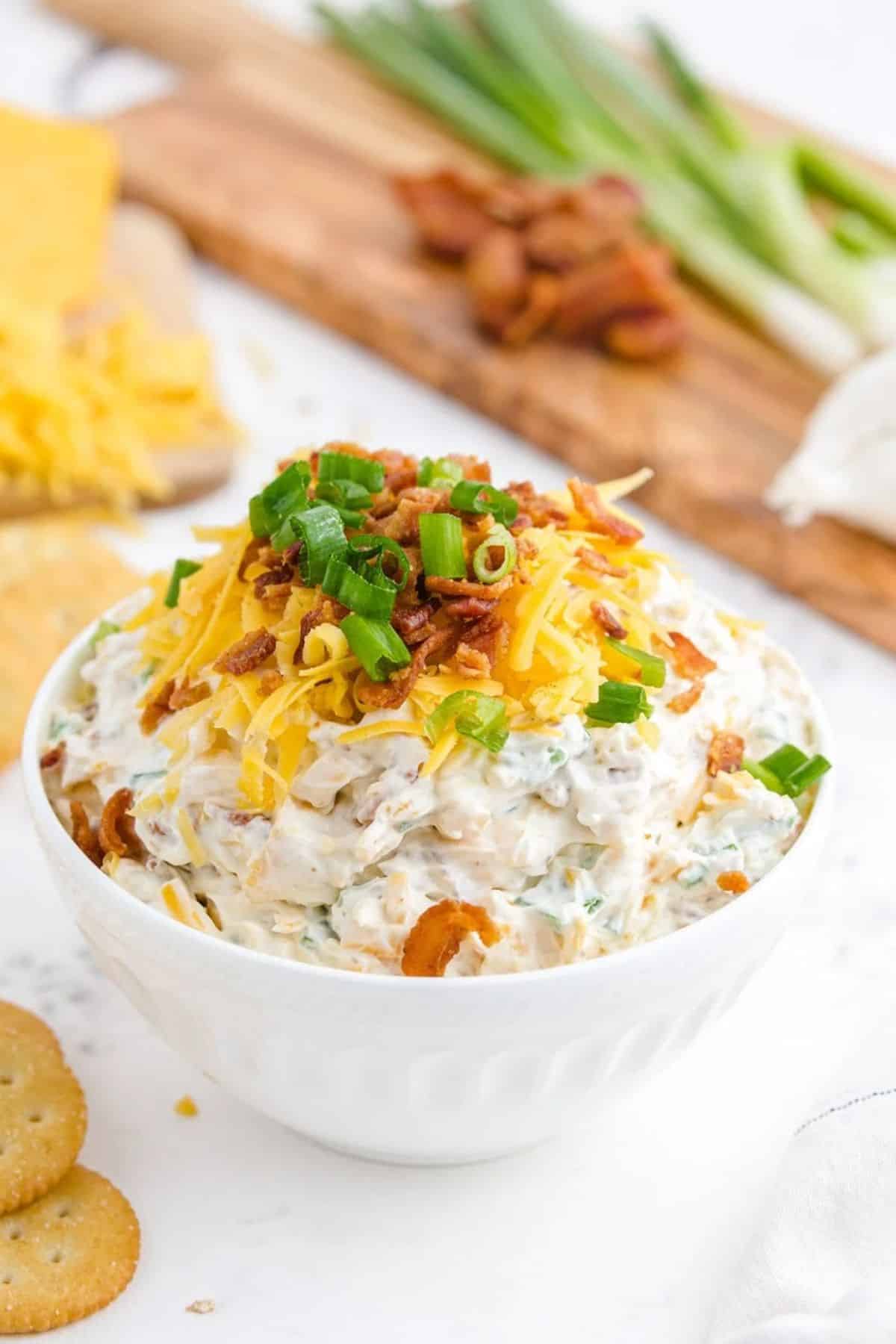 Scrumptious million dollar dip in a white bowl.