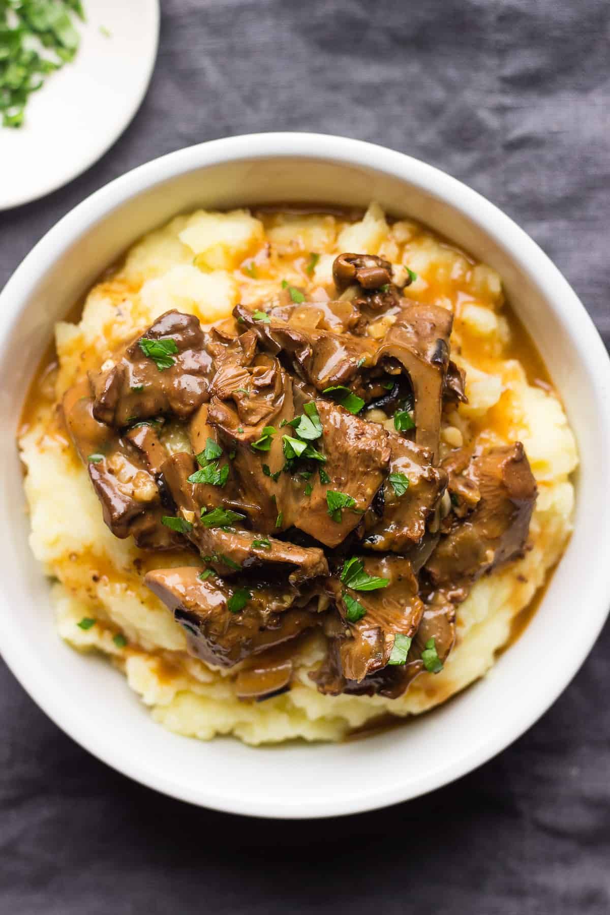 Juicy mushroom stroganoff in a white bowl.