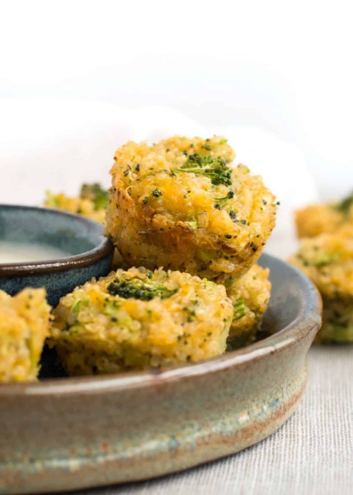 Crispy broccoli cheddar quinoa bites on a tray.