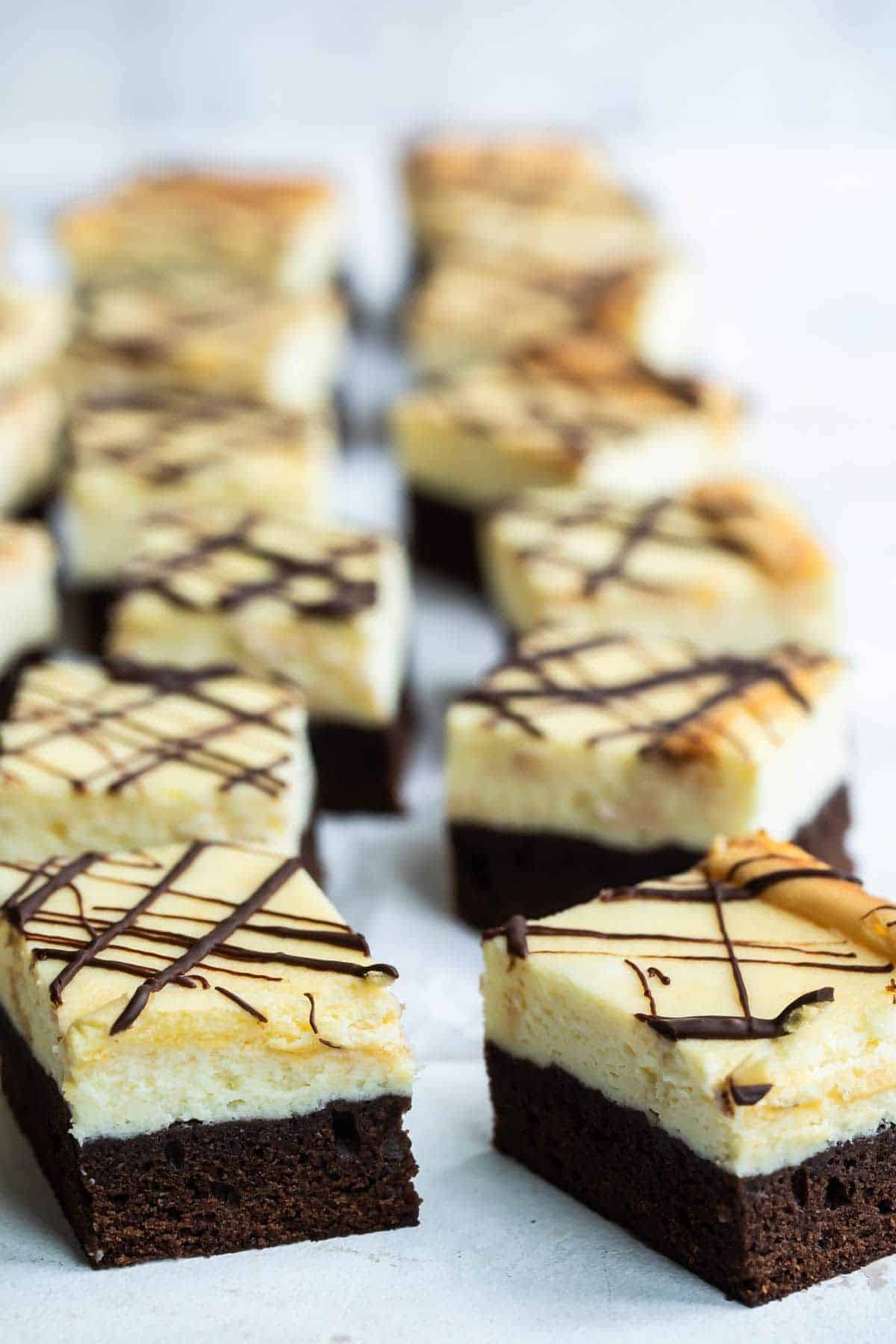Delicious sour cream cheesecake brownies on a table.