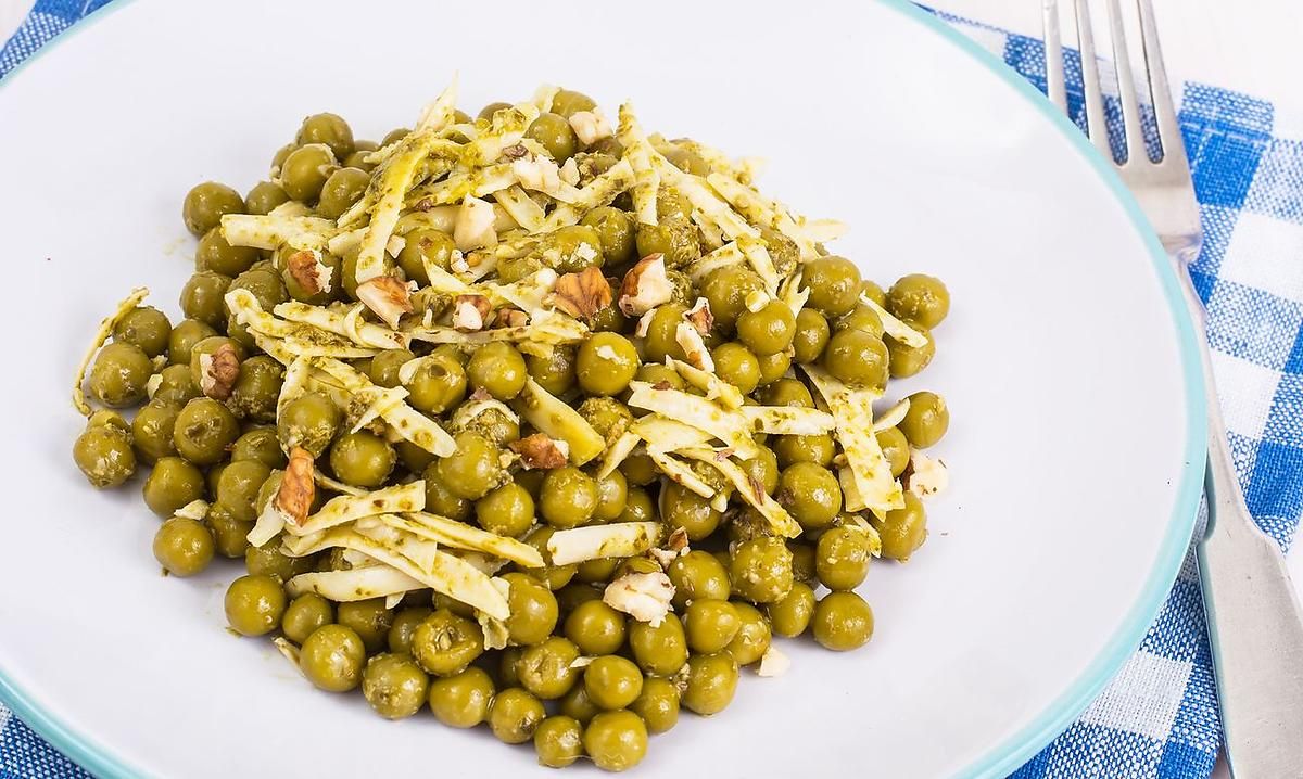 Delicious green peas with pesto on a plate.