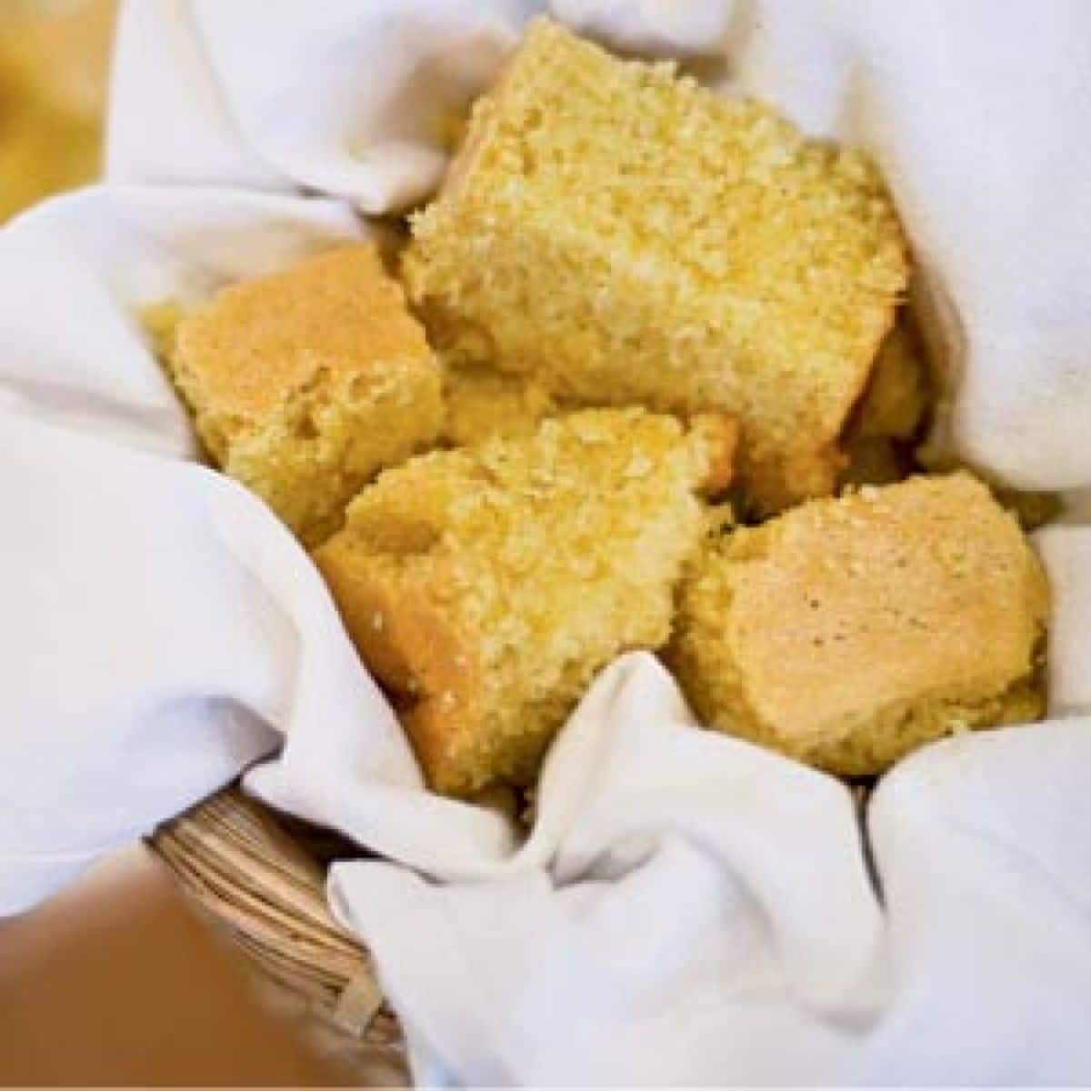 A few delicious cornbread pieces in a basket.