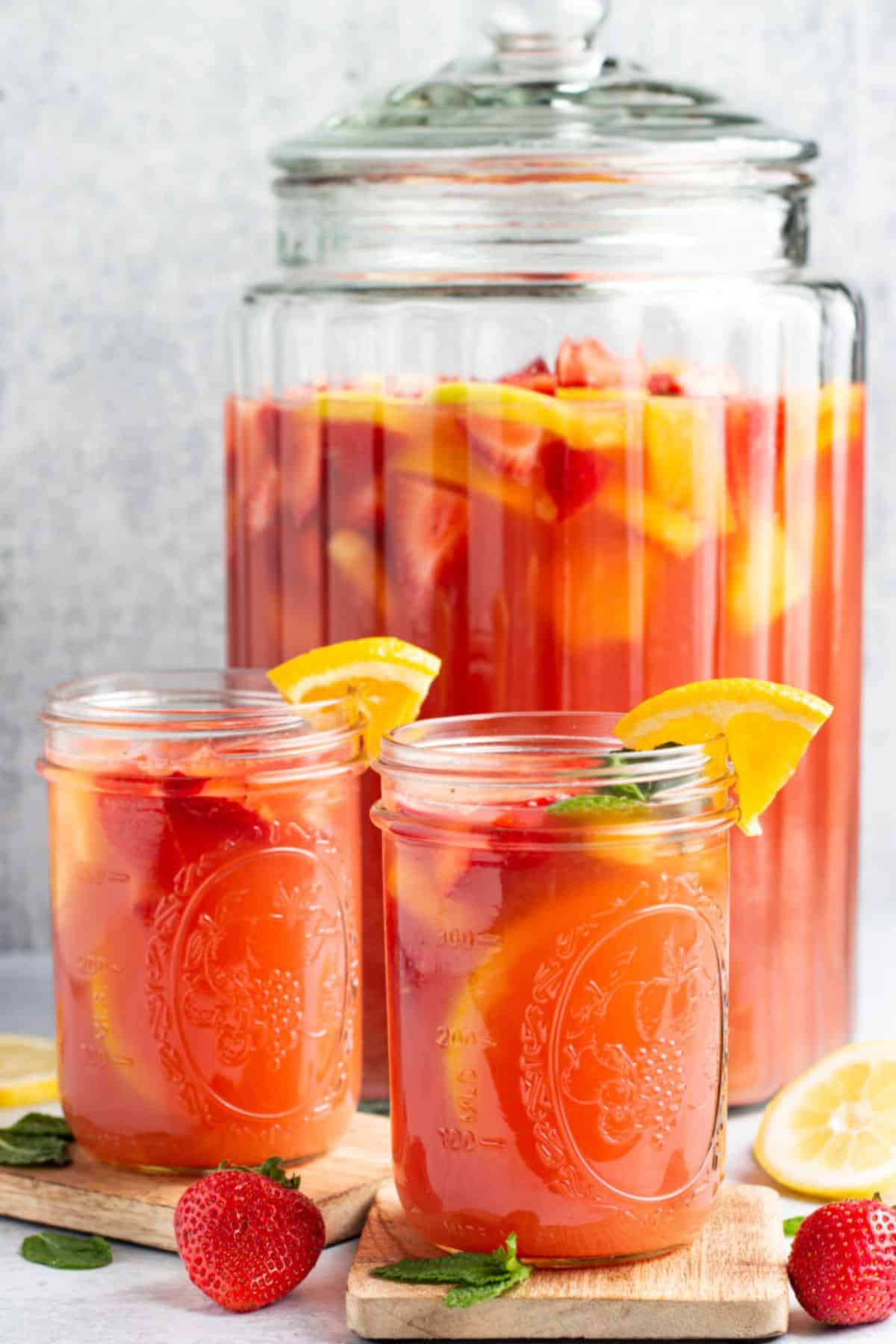 Fresh alcoholic jungle juice punch in glass jars.