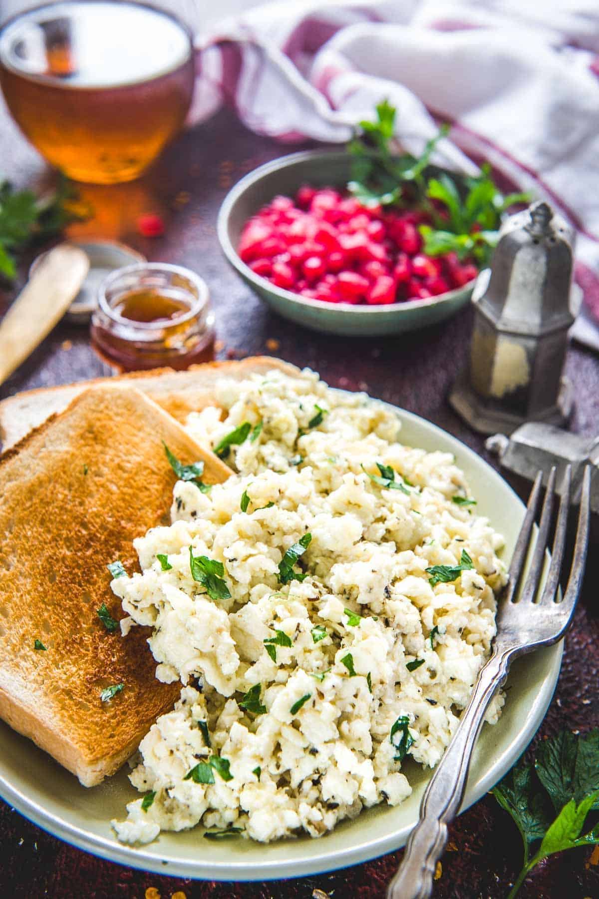 Delicious scrambled egg whites with toasts on a plate with a fork.