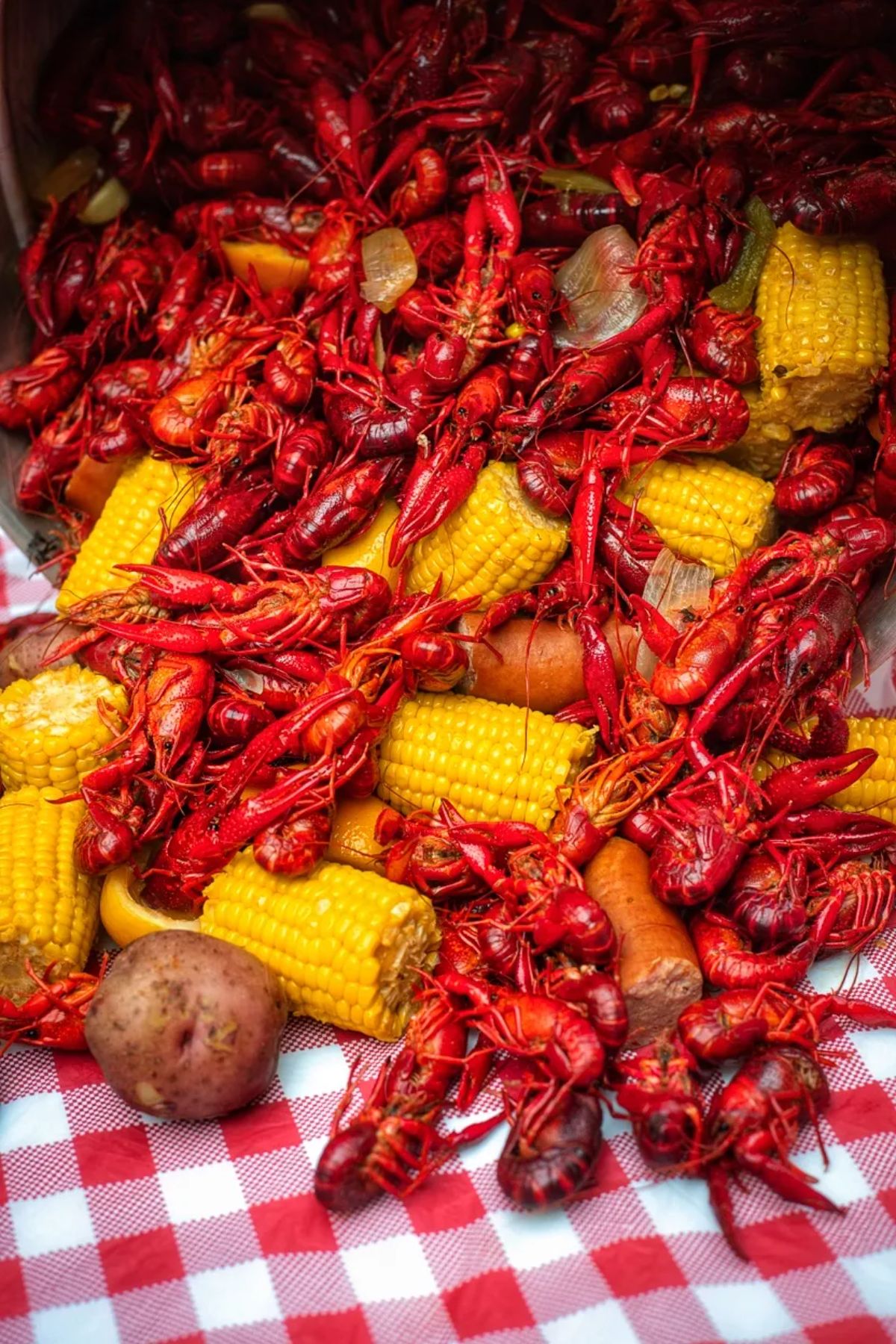 Scrumptious louisiana crawfish boil poured from a pot on a table.