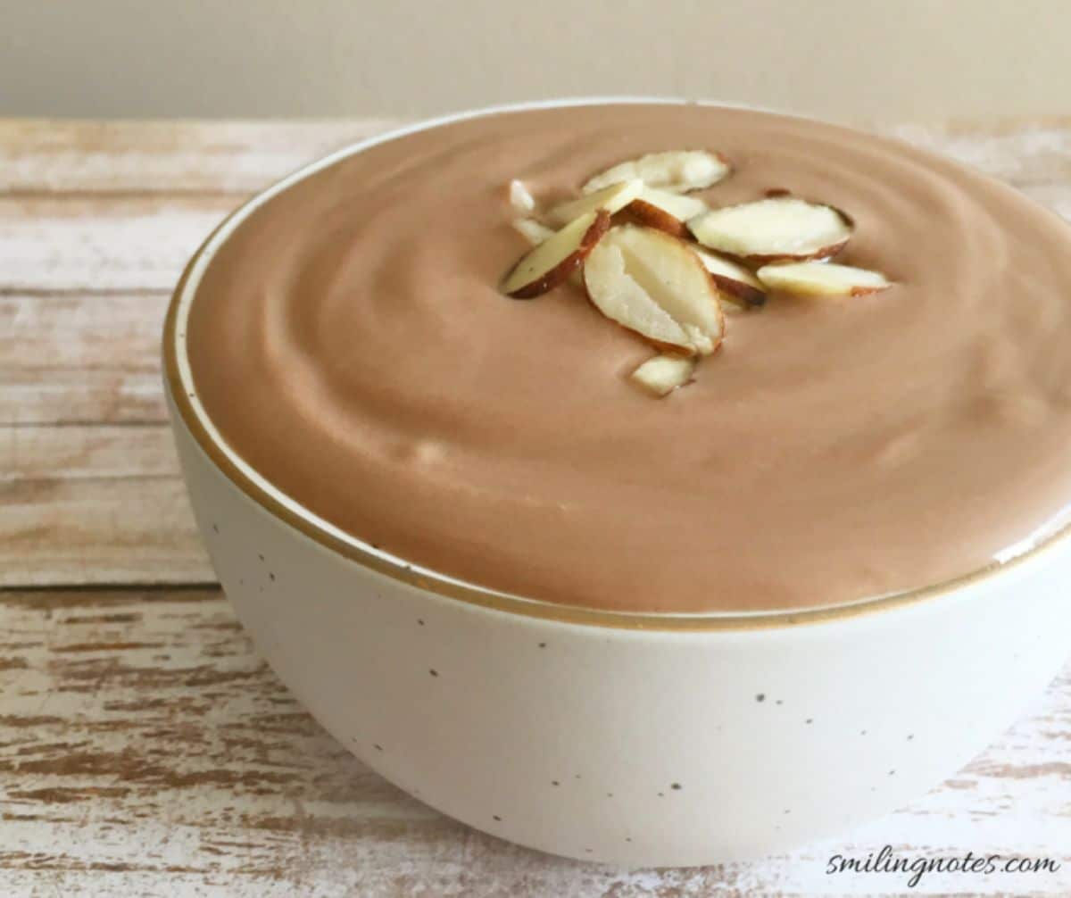 Flavorful greek yogurt chocolate mousse in a white bowl.