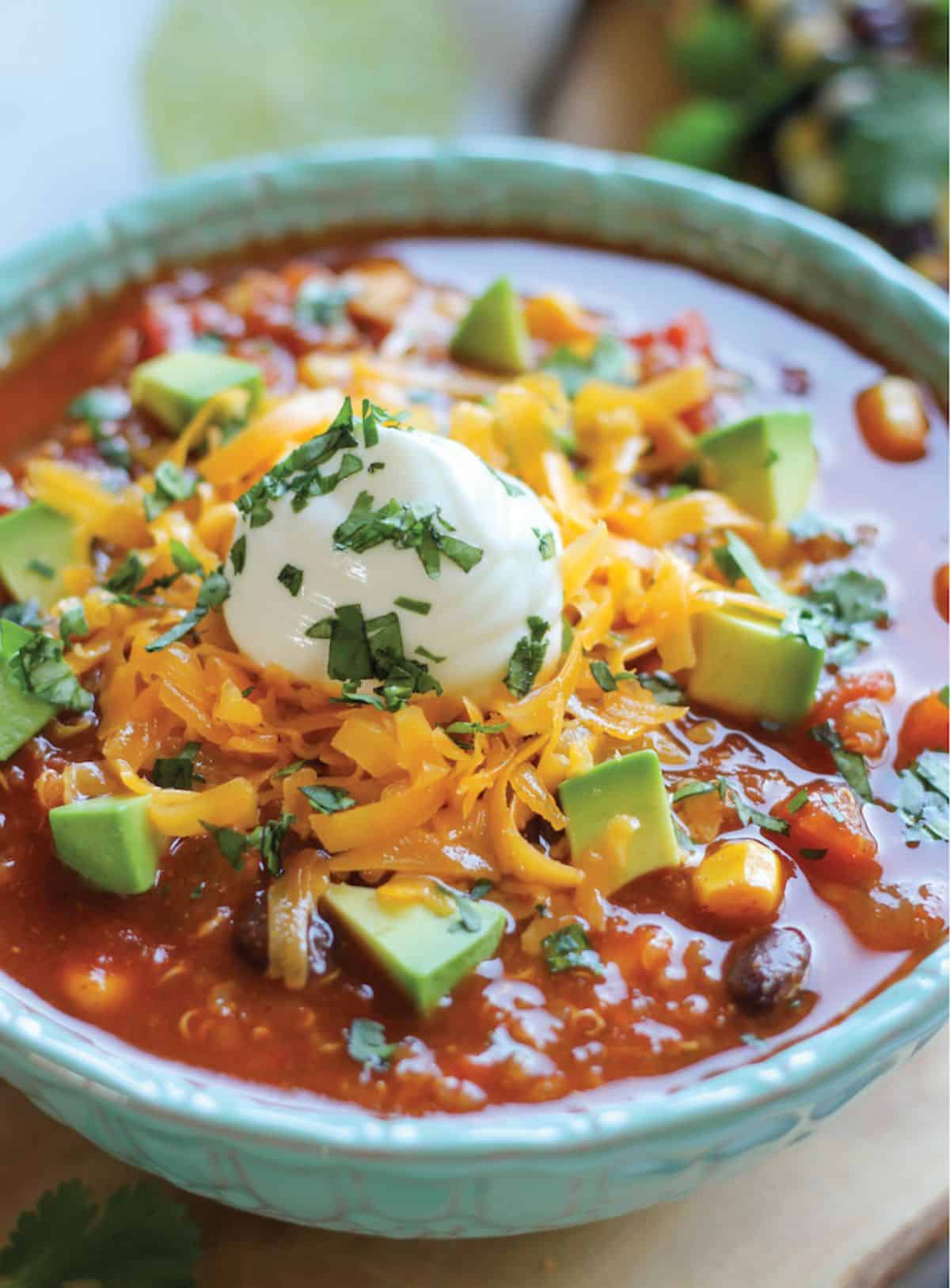 Juicy quinoa chili in a blue bowl.