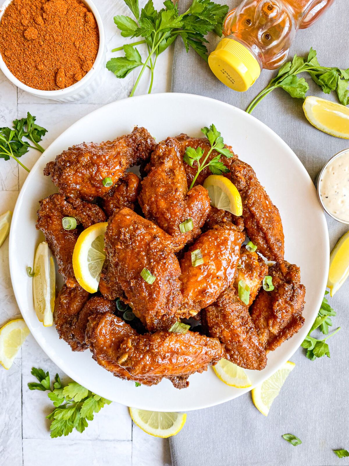 Scrumptious honey old bay chicken wings on a white plate.