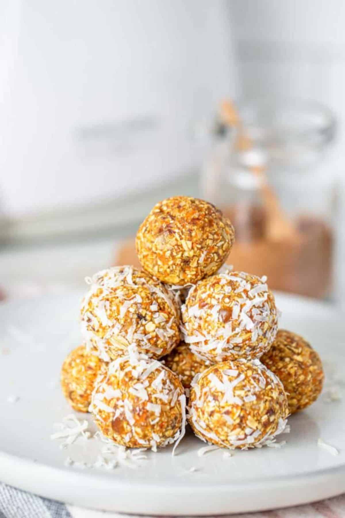 A pile of carrot cake energy balls on a white plate.