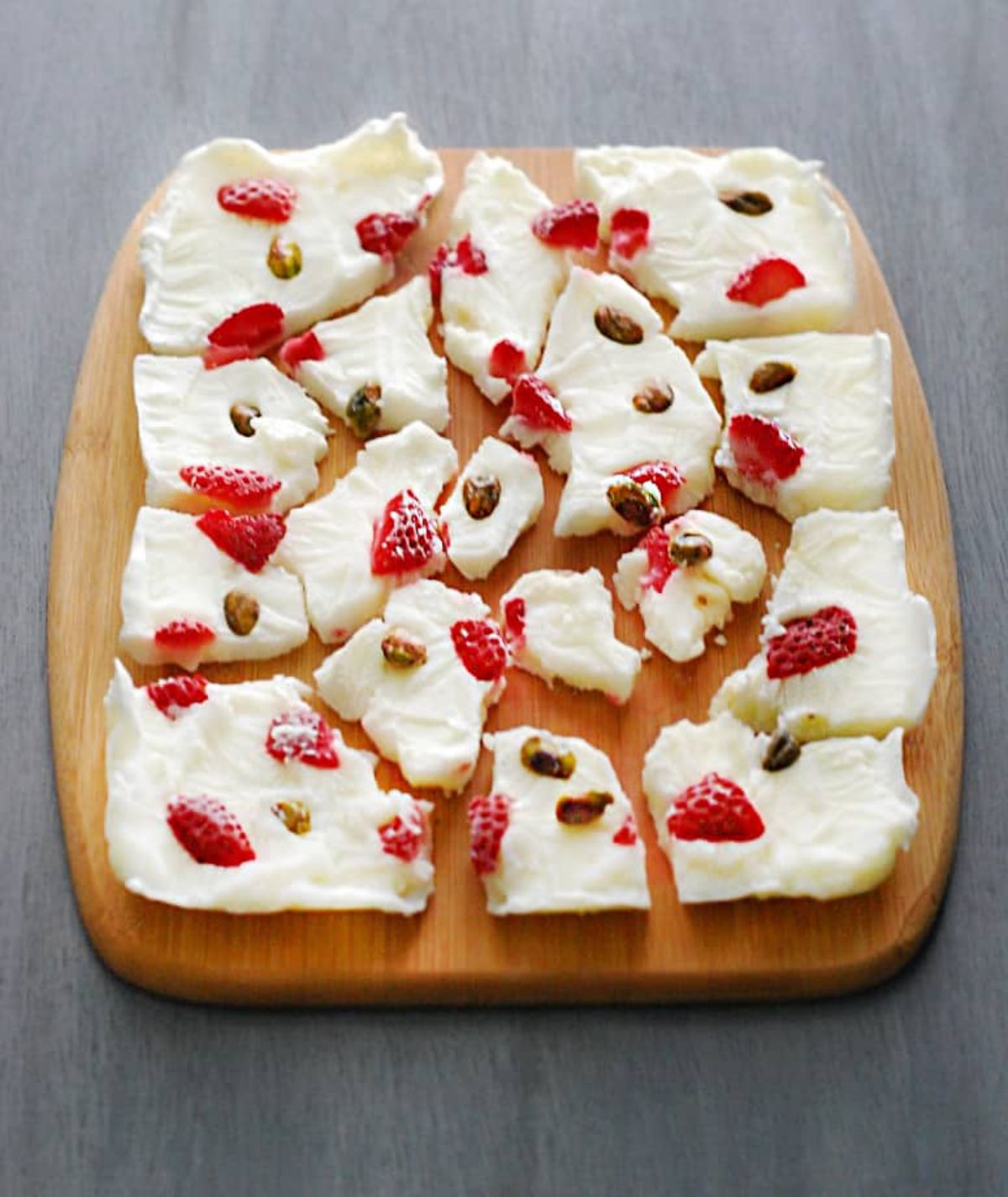 Scrumptious yogurt bark sliced on a wooden tray.