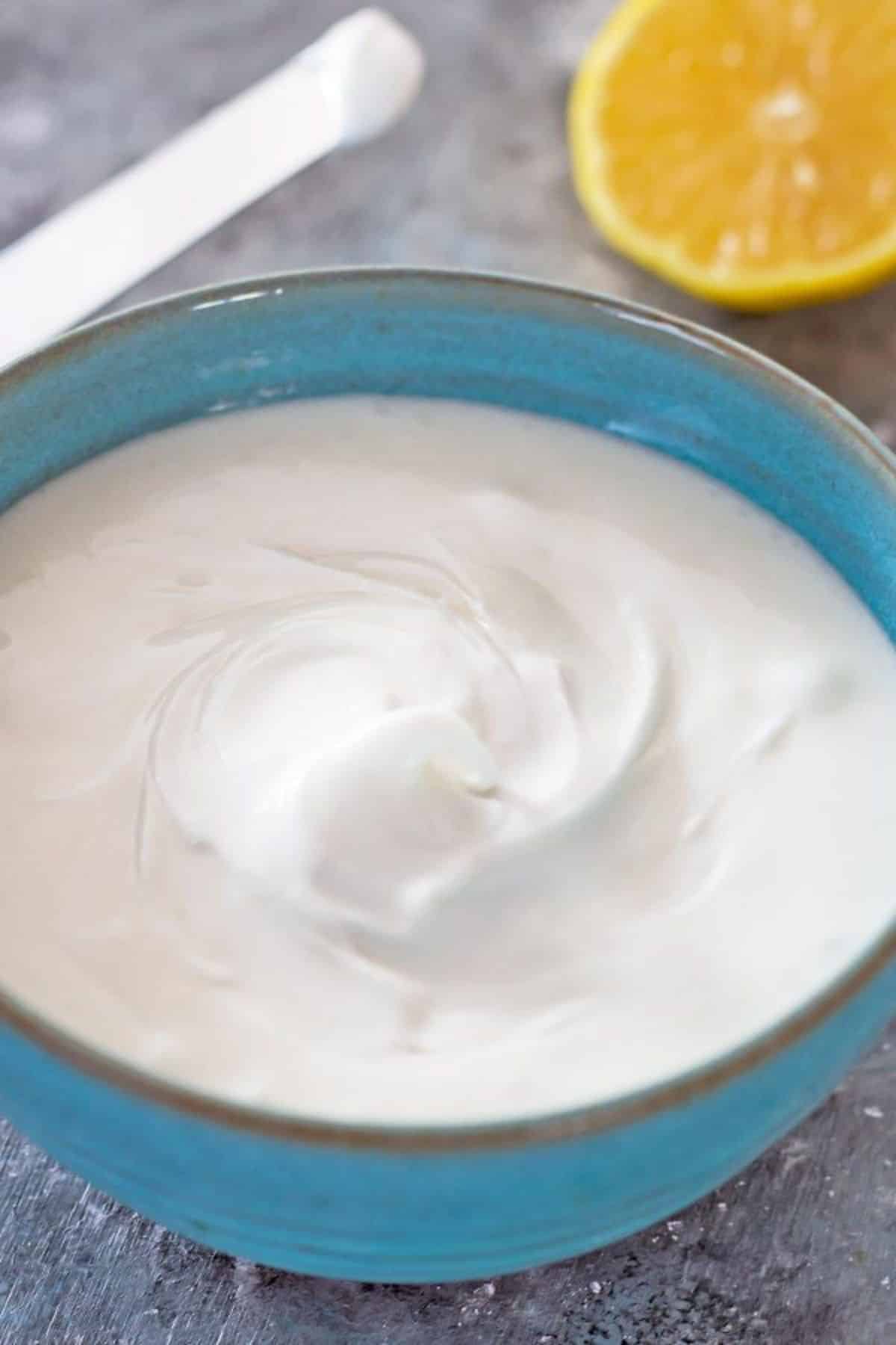 Creamy royal icing in a blue bowl.