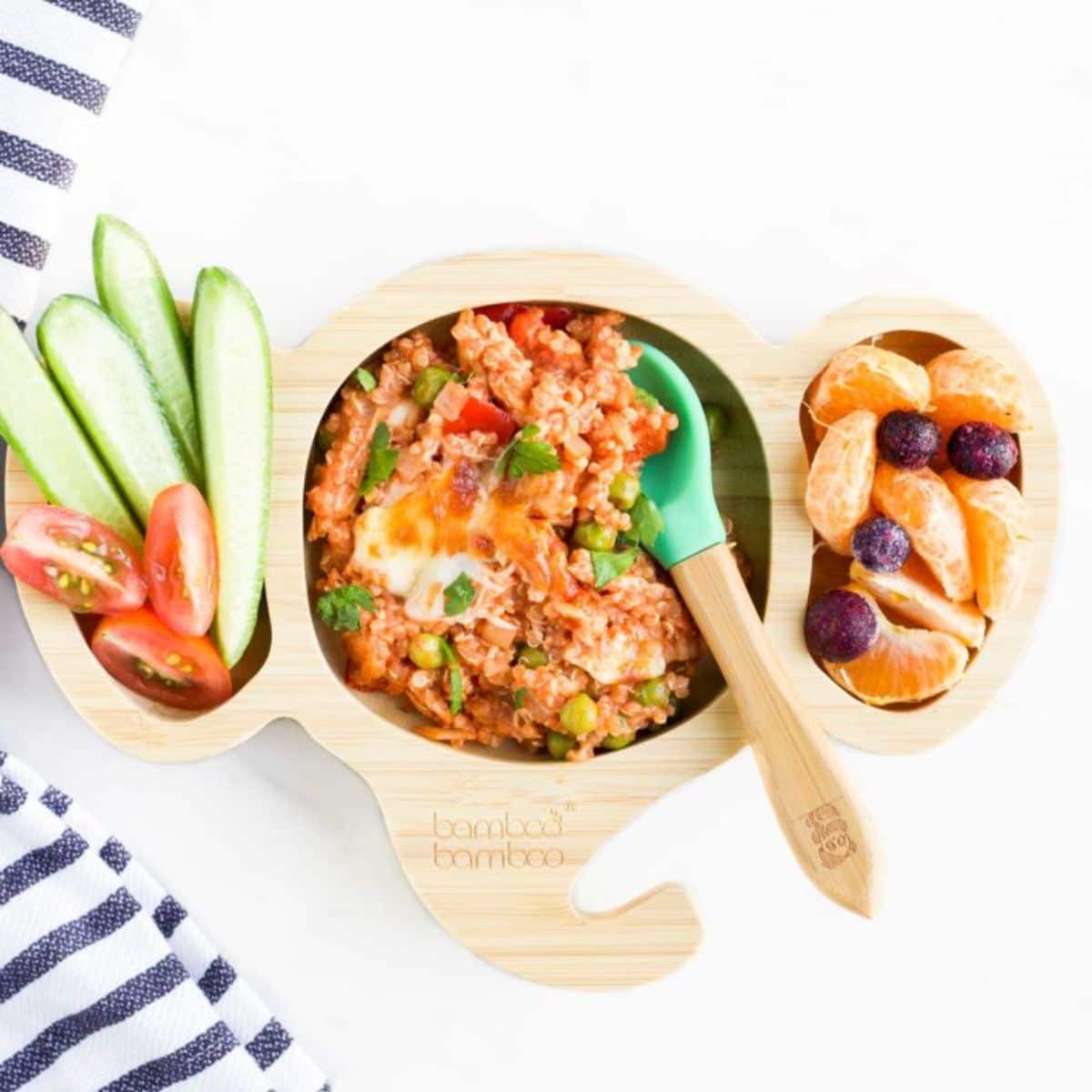 Chicken quinoa bake with fruits and beggies in a wooden bowl.