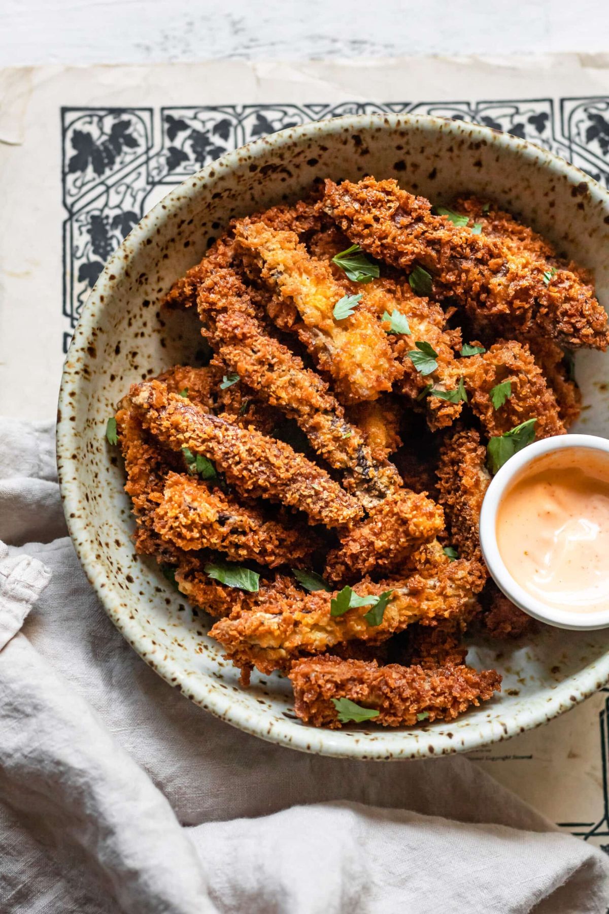 Crispy portobello mushroom fries in a gray bowl.