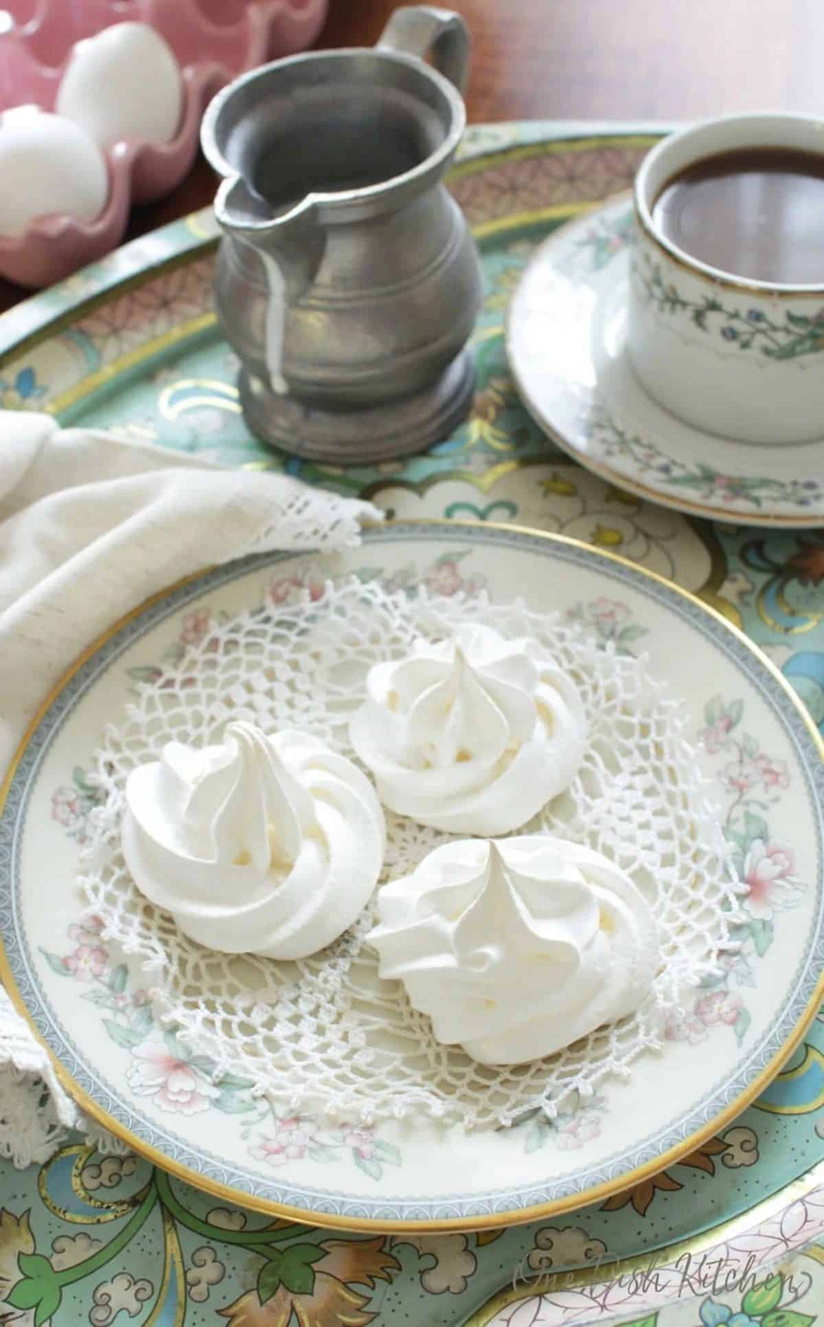 Sweet meringue cookies on a colorful plate.