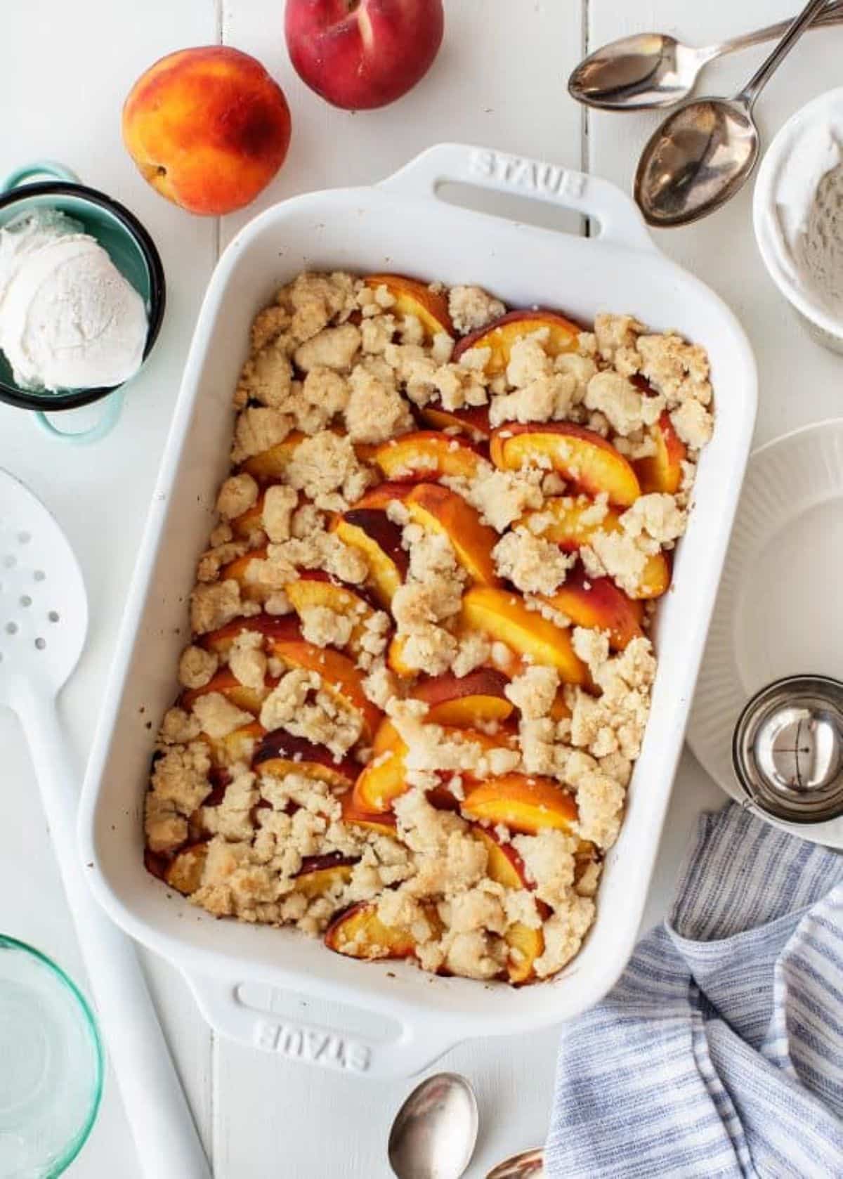 Scrumptious easy peach cobbler in a white casserole.