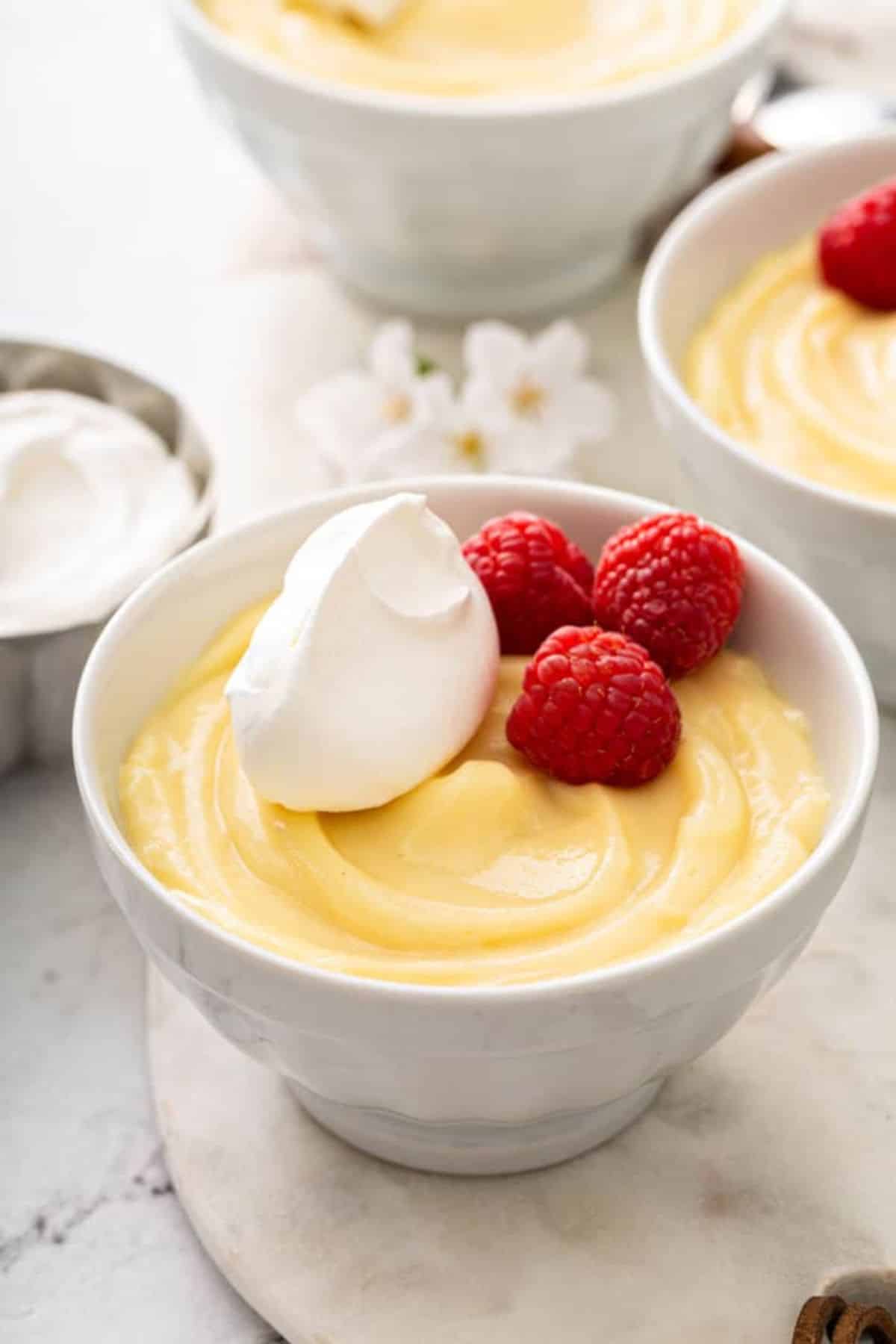 Mouth-watering homemade vanilla pudding in a white bowl.